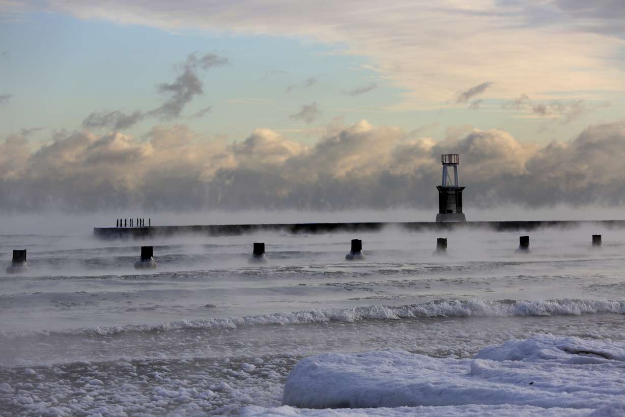 Lake Michigan is steaming in the morning as temperatures dipped below zero at North Avenue Beach, Tuesday, Dec. 26, 2017, in Chicago. Meteorologists warn of sub-zero frigid arctic air and dangerously cold wind chills. (Nancy Stone/Chicago Tribune via AP)