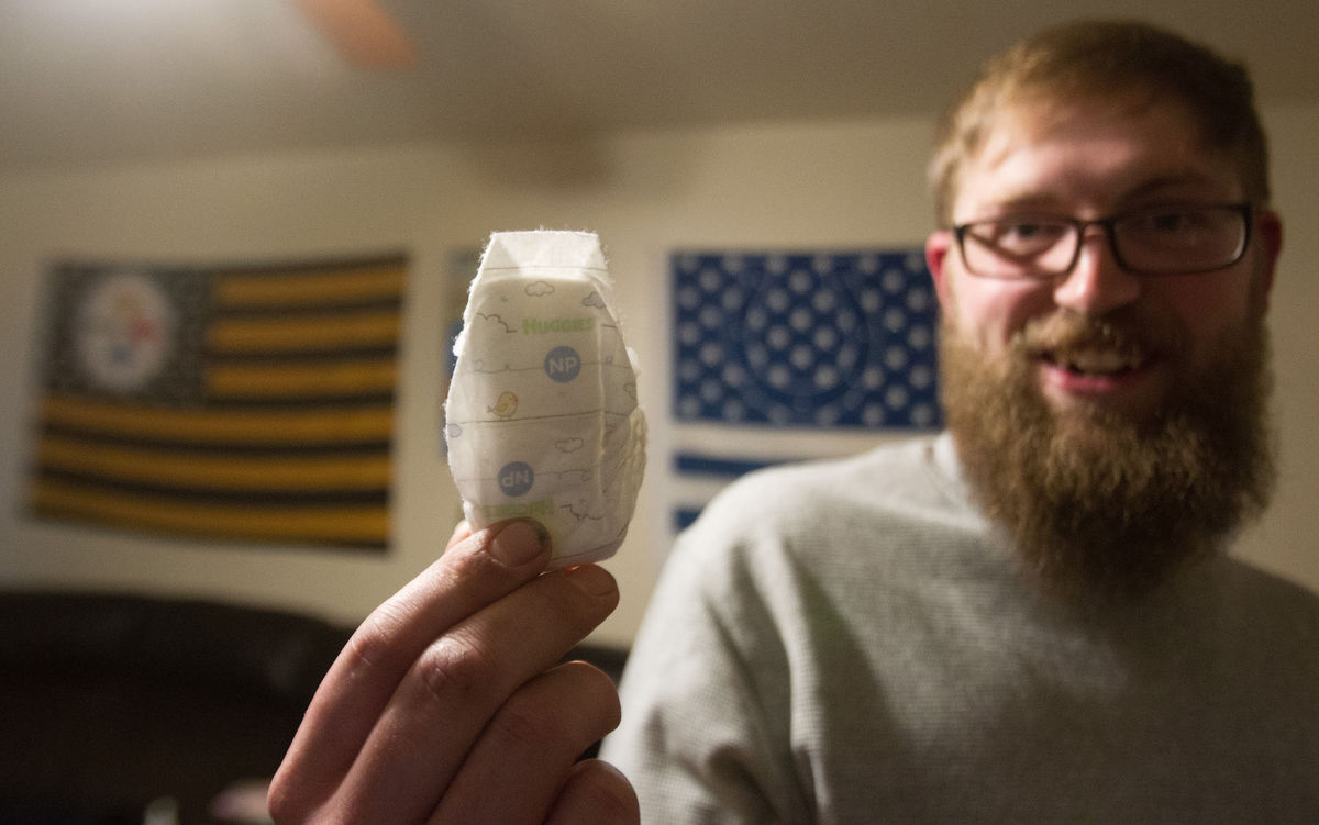 Steven Crabb, 26, shows the size of the diaper his daughter Rainna wore when she was born prematurely at 24 weeks. (Photo: Drew Nash, Times-News)