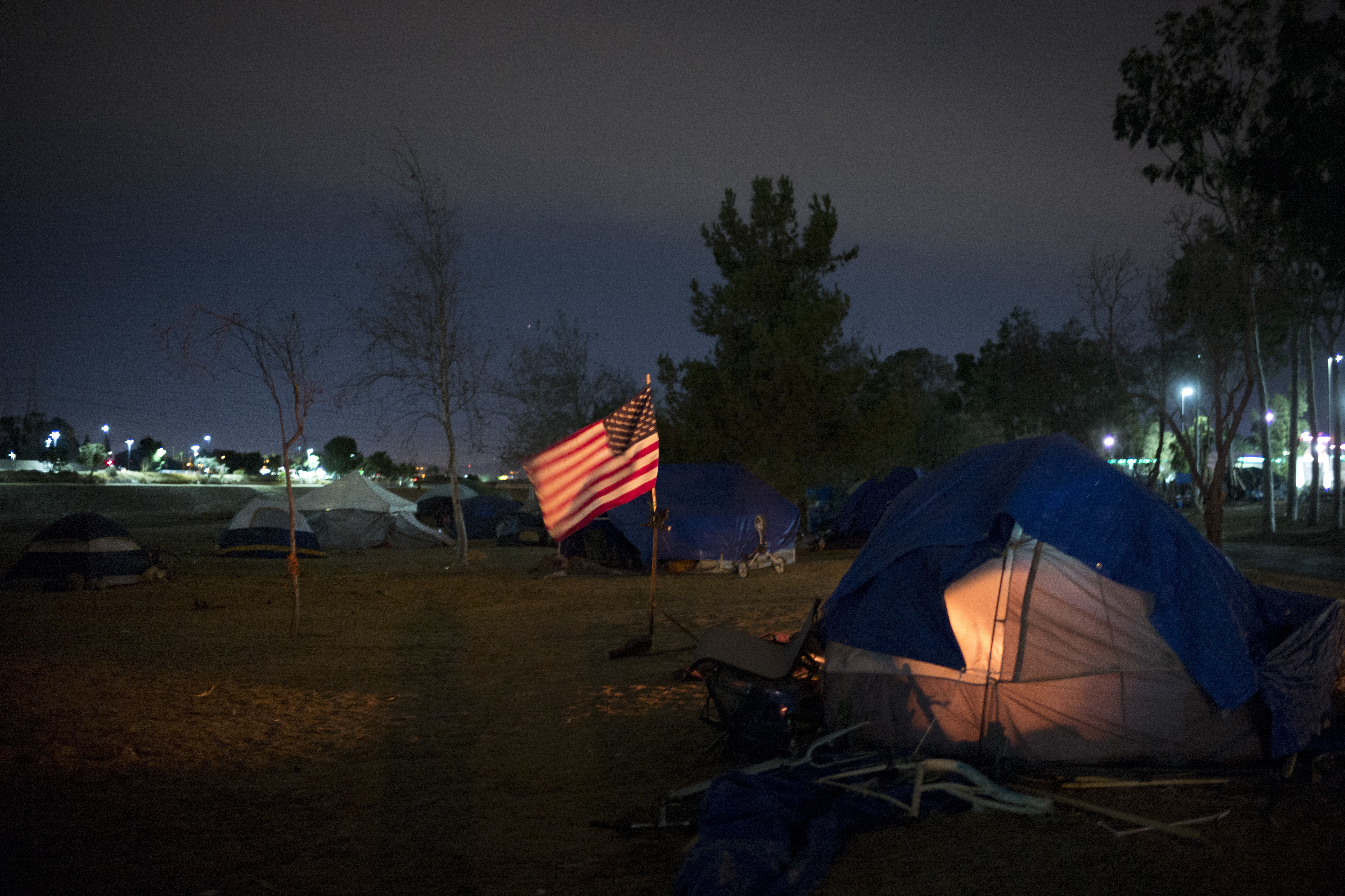 Homeless tents are pitched around an America flag along the Santa Ana River trail Sunday, Dec. 10, 2017, in Anaheim, Calif. Photo: Jae C. Hong, AP Photo