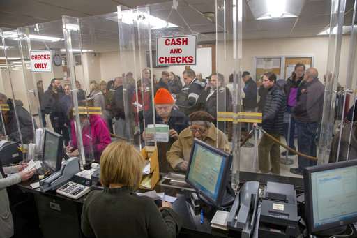In this Dec. 26, 2017 photo, people line-up at the Town of Hempstead tax receiver's office to pay their real estate taxes before the end of the year. Photo: Howard Schnapp, Newsday via AP