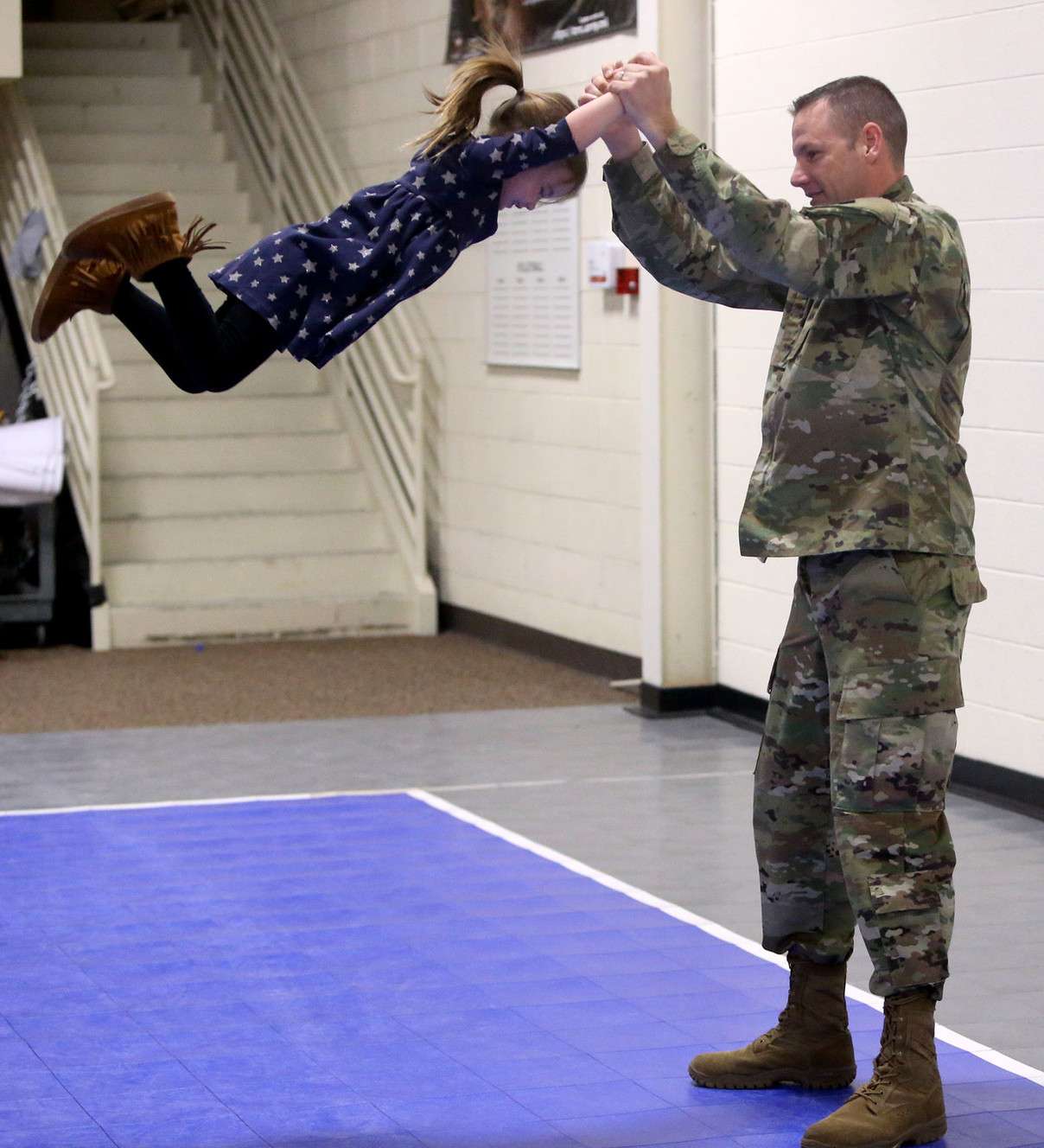 Staff Sgt. Joel Yoder plays his daughter, Minnie Mae, 4, while his wife takes photos of them after a departure ceremony at the Utah National Guard geadquarters in Draper on Thursday, Dec. 28, 2017. Fifteen soldiers from the Guard’s 142nd Military Intelligence Battalion are leaving for a 12-month deployment to Afghanistan in support of Operation Freedom Sentinel. (Photo: Kristin Murphy, KSL)
