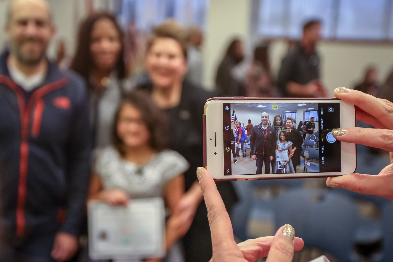 Lachlan Murray, from China, has her picture taken with Rep. Mia Love, R-Utah, and her parents after a citizenship ceremony for children at the U.S Citizenship and Immigration Services' office in Salt Lake City on Thursday, Dec. 28, 2017. (Photo: Adam Fondren, KSL)