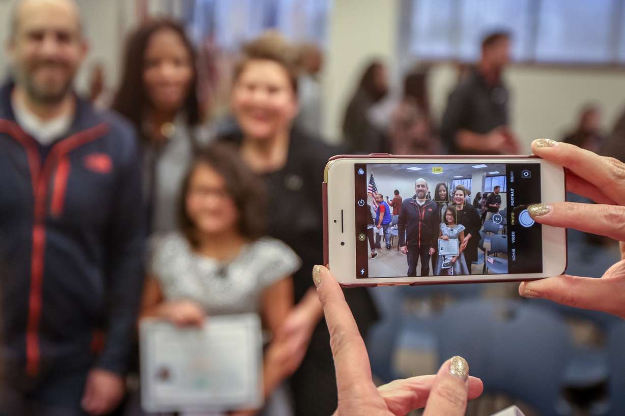 Lachlan Murray, from China, has her picture taken with Rep. Mia Love, R-Utah, and her parents after a citizenship ceremony for children at the U.S Citizenship and Immigration Services' office in Salt Lake City on Thursday, Dec. 28, 2017. (Photo: Adam Fondren, KSL)
