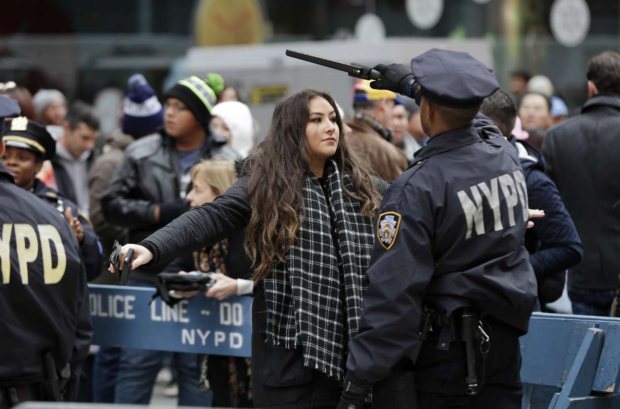 In this Dec. 31, 2015 file photo, pedestrians submit to a search as they enter Times Square in New York. Photo: Seth Wenig, AP Photo