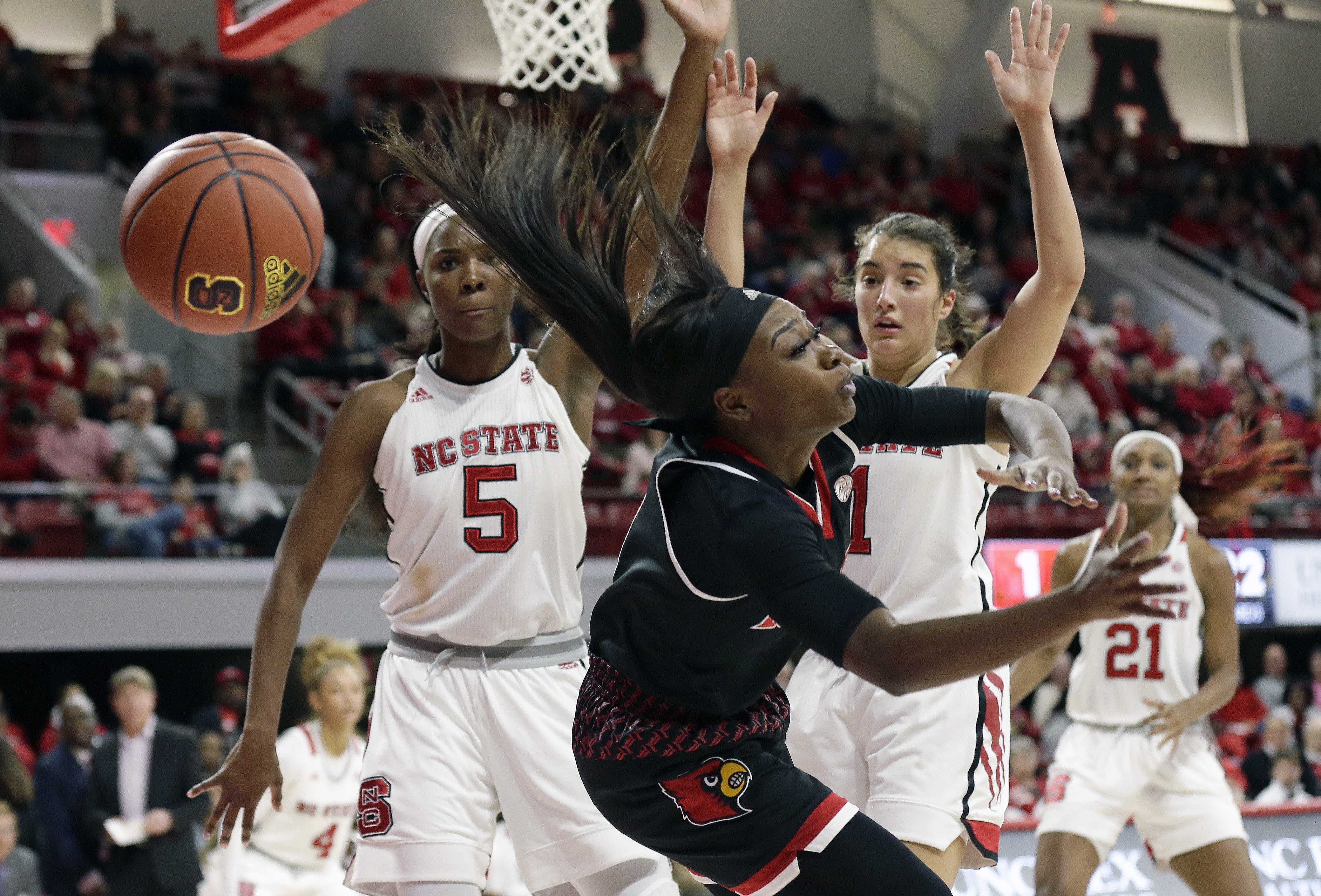 No.3 Louisville holds off Wolfpack 55-47.