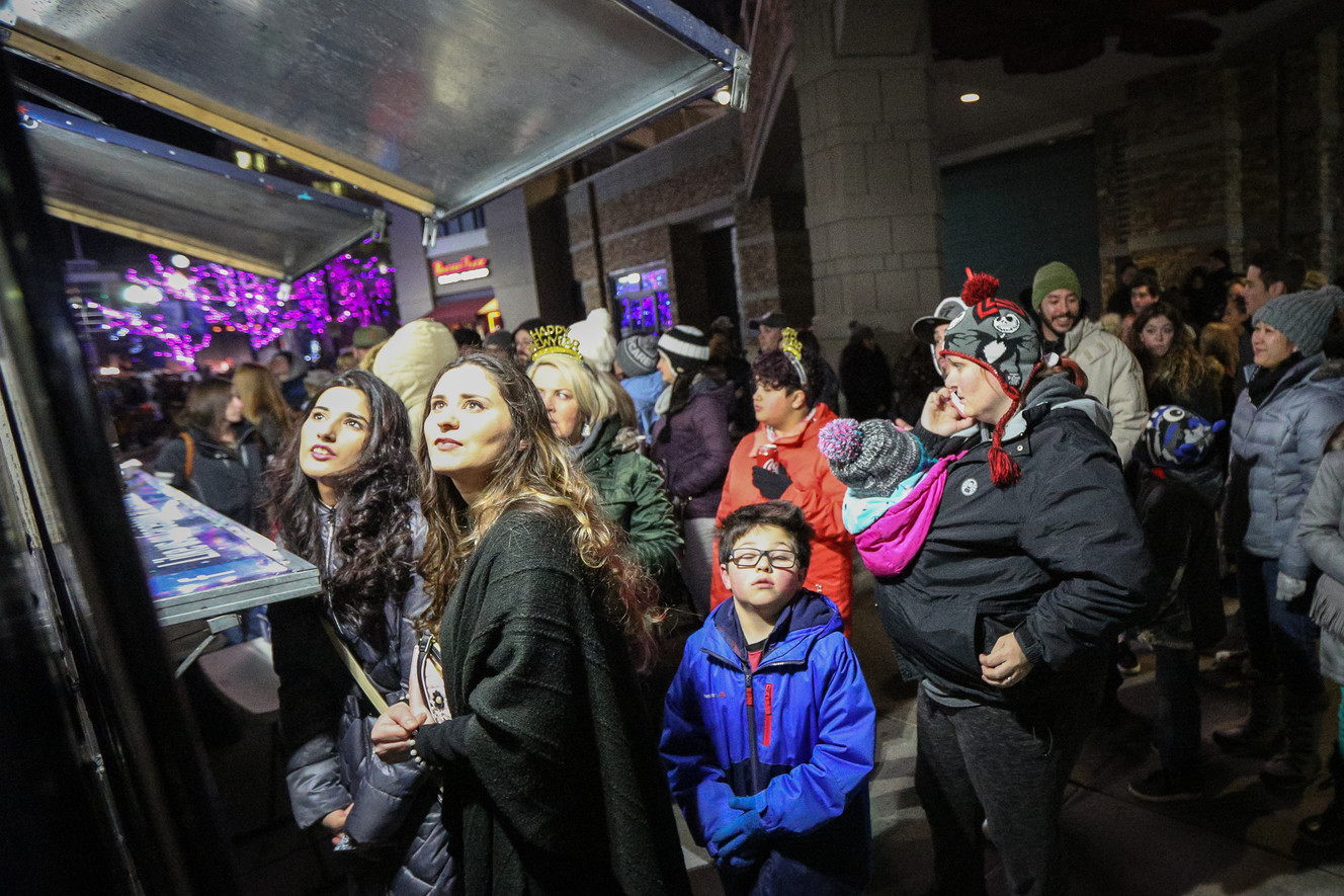 Sara Kisana,, left, and Ikram Abdullah look at the menu before ordering from the food truck Fry Me to The Moon at Last Hurrah, a downtown New Year's Eve party and festival at the Gateway in Salt Lake City on Sunday, Dec. 31, 2017. (Photo: Adam Fondren, KSL)