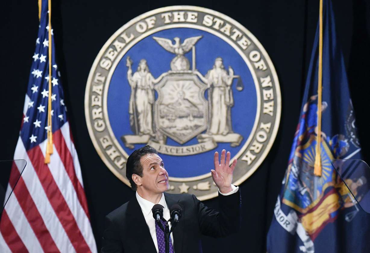 New York Gov. Andrew Cuomo makes reference to his father Mario Cuomo as he delivers his state of the state address at the Empire State Plaza Convention Center in Albany, N.Y. on Wednesday. During the speech, Cuomo pledged to sue over the new federal tax plan, which he called “an assault” by the federal government. (AP Photo)