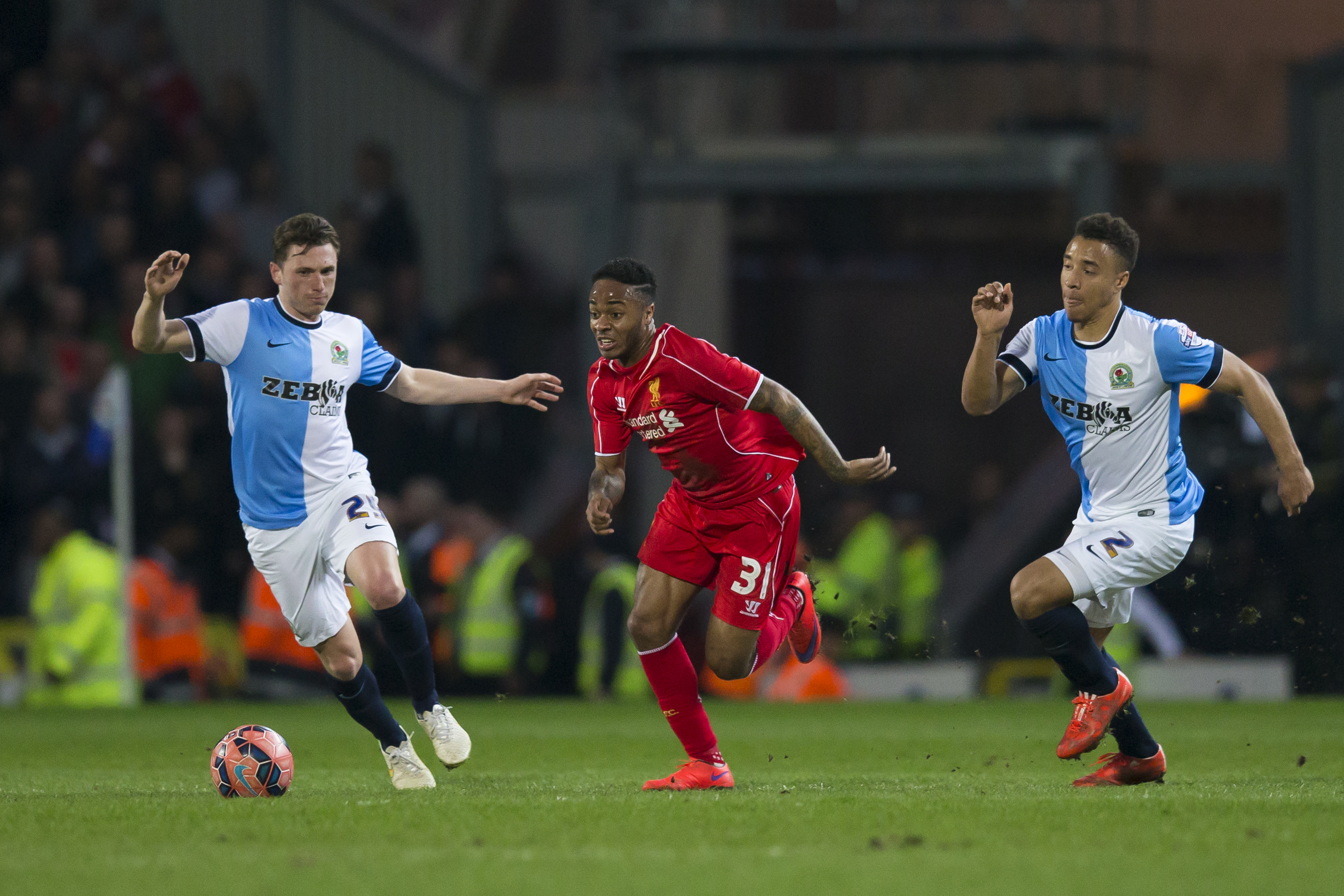 Blackburn's Adam Henley, right, and Corry Evans fight for the ball against Liverpool's Raheem Sterling, center, during the English FA Cup sixth round replay soccer match between Blackburn and Liverpool at Ewood Park Stadium, Blackburn, England, Wednesday, April 8, 2015. (AP Photo/Jon Super)