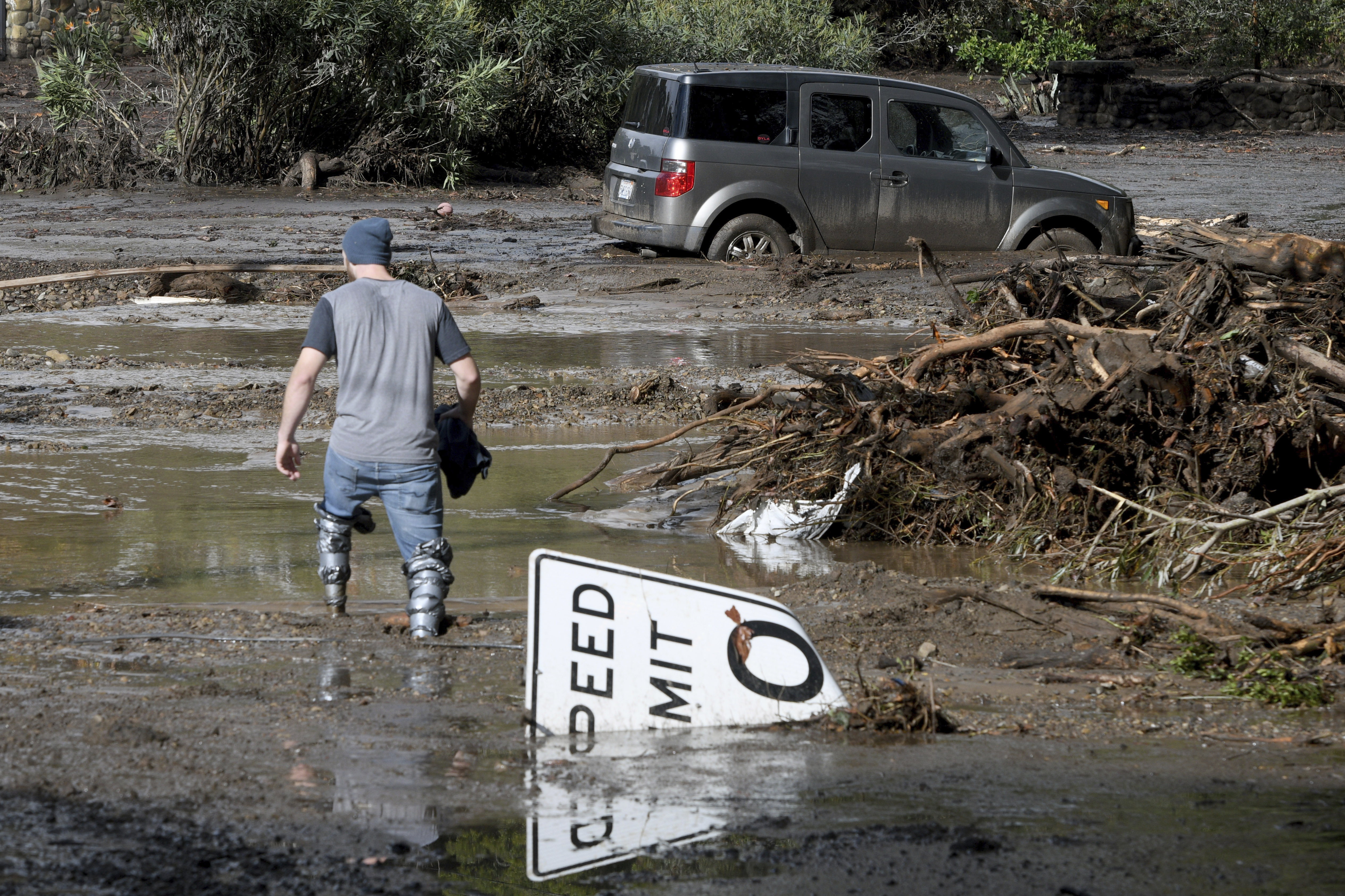 California storm: Cars swept away, body pinned against home