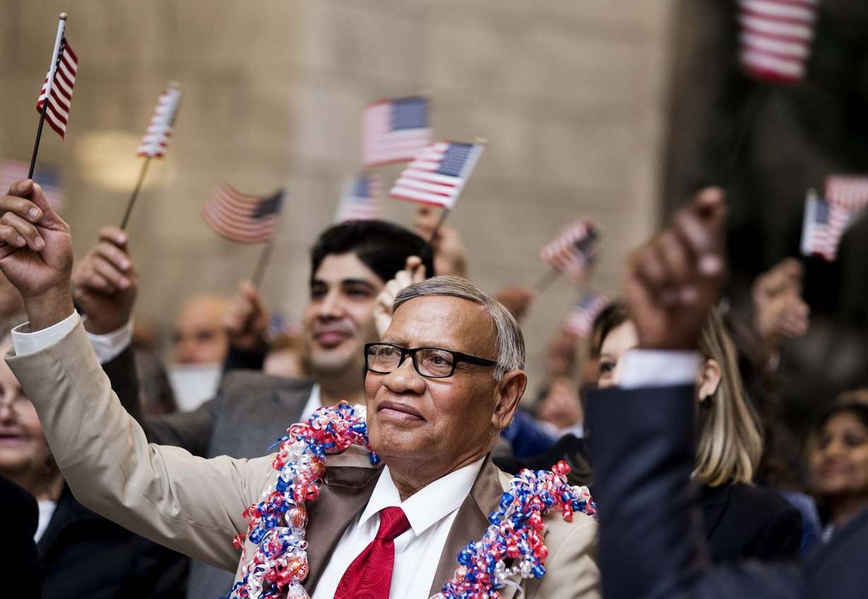 Taniela Leka, originally from Tonga, waves an American flag after taking the oath of allegiance during a naturalization ceremony at the Capitol in Salt Lake City on Friday, Jan. 12, 2018. (Photo: Laura Seitz, KSL)