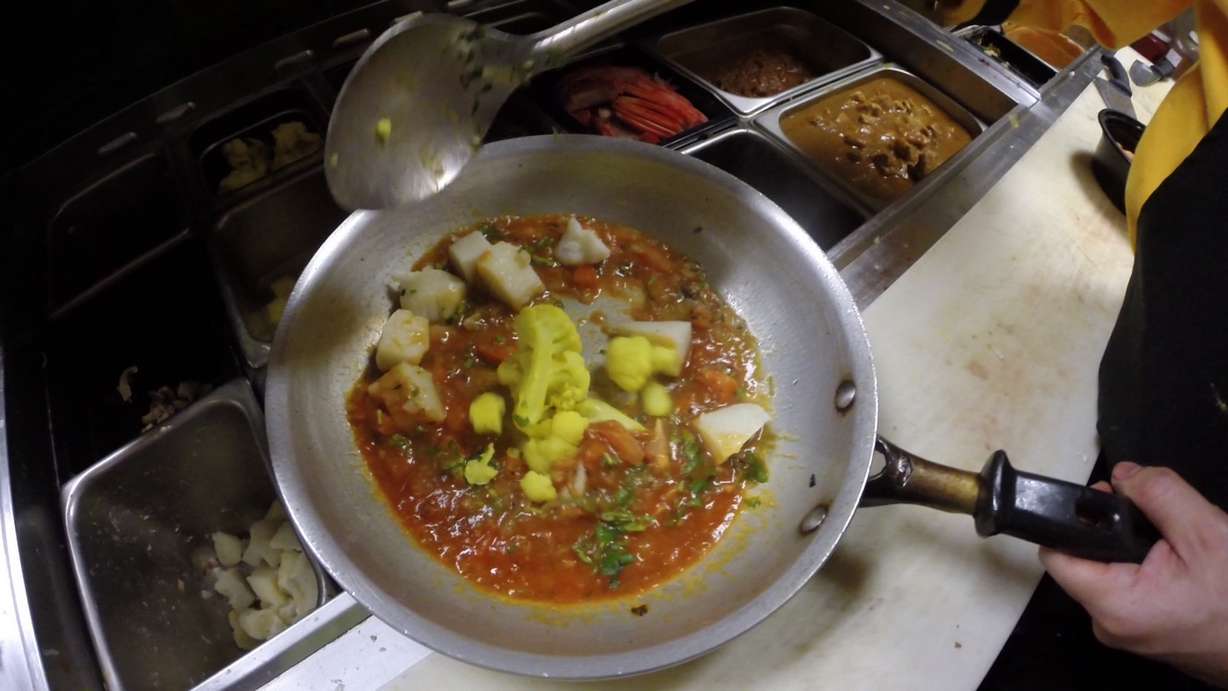 A chef scoops cauliflower into a pan at the Bhutan House Restaurant in Sandy on Tuesday, Jan. 9, 2018. (Photo: Ray Boone, KSL TV)