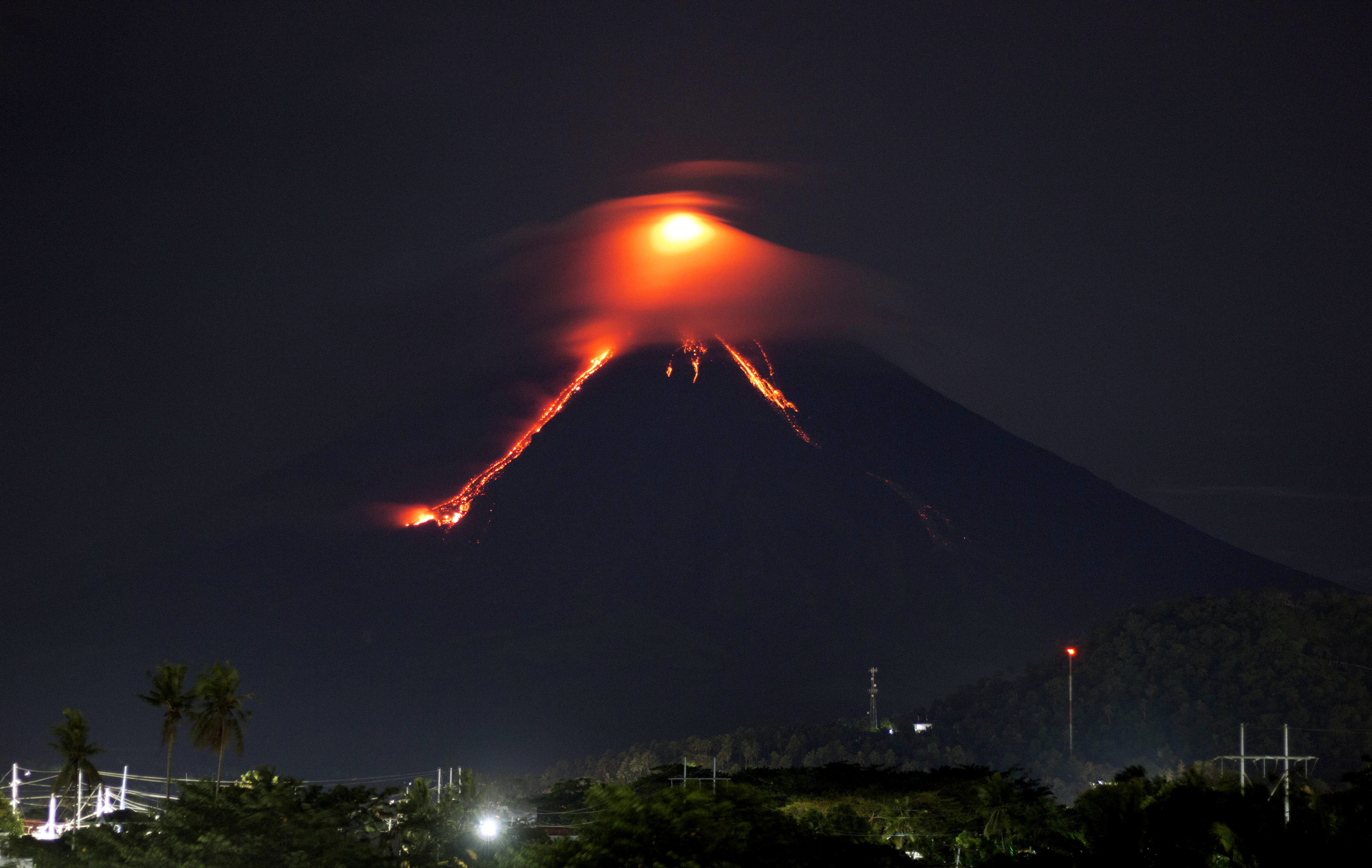Glowing red lava rolls down slopes of Philippine volcano