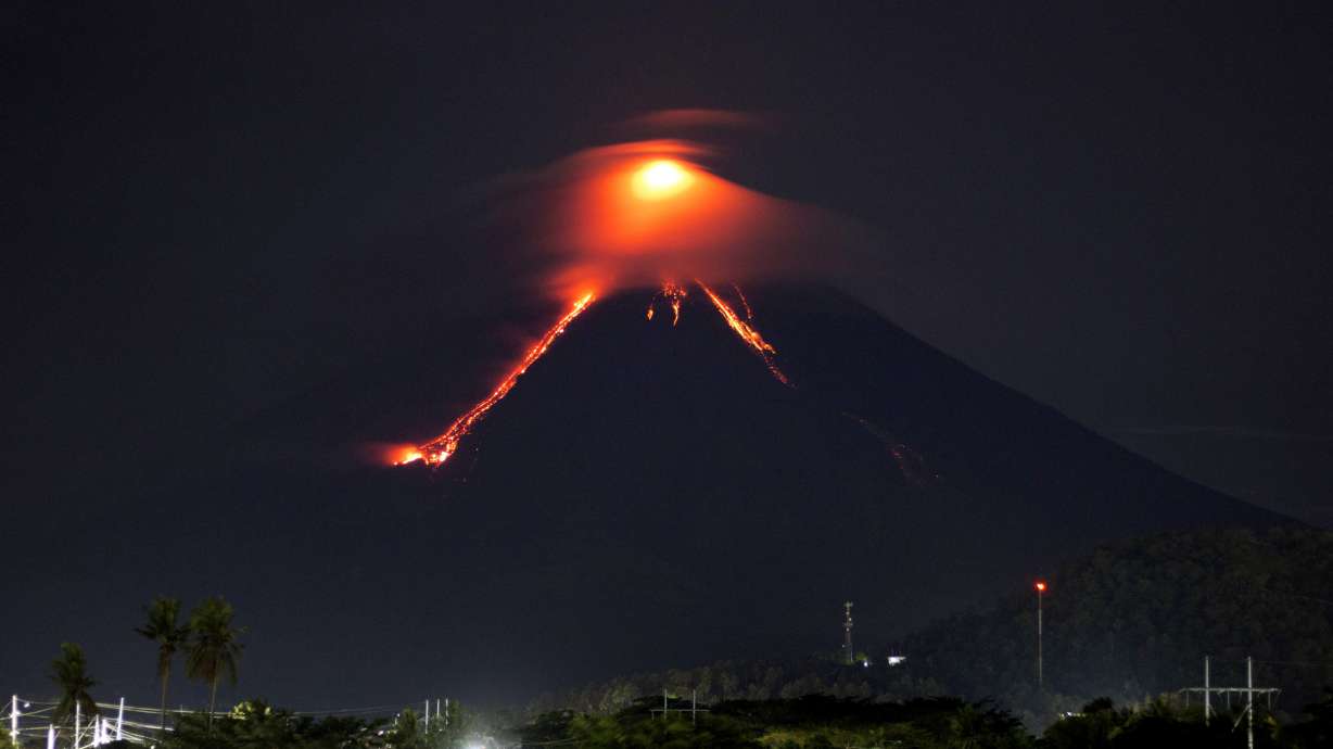 Glowing red lava rolls down slopes of Philippine volcano