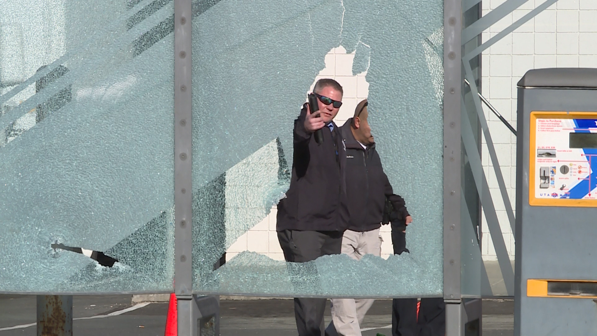 Investigators go through the parking lot of a Magna liquor store looking for evidence near where two people were shot Tuesday morning. (Photo: Jay Dortzbach, KSL TV)