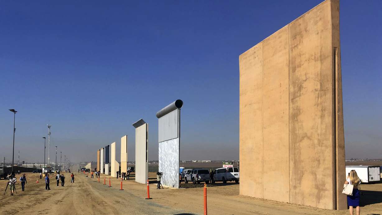 The Latest: Border wall's height draws praise, criticism