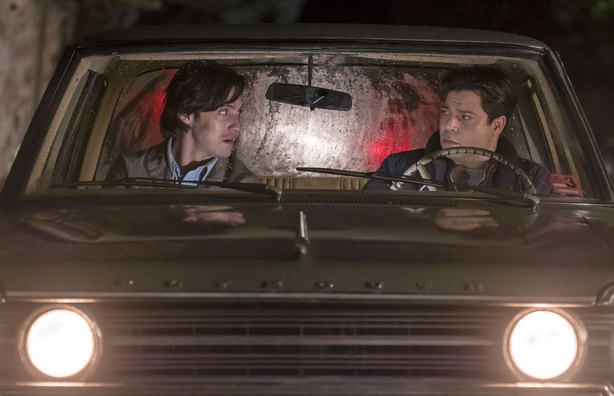 In this image released by NBC, Milo Ventimiglia, left, and Jeremy Luke appear in a scene from "This is Us." The heartwarming NBC series was second only to CBS' "NCIS" for the most popular show of the week for its debut season finale last week. The show reached 12.8 million viewers on the night it first aired, with the audience swelling to 16.9 million when people who watched via time delay over three days is added in, the Nielsen company said. (Ron Batzdorff/NBC via AP)