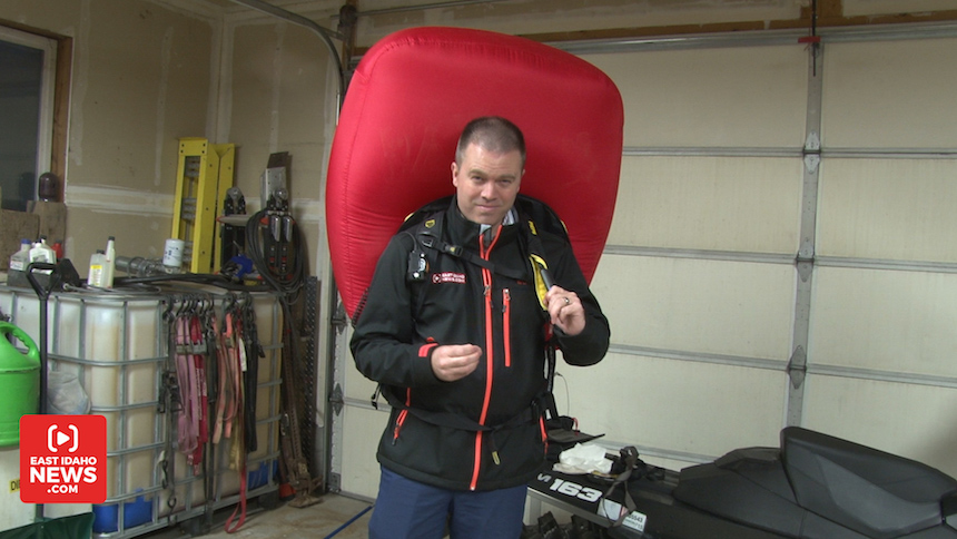 EastIdahoNews.com reporter Nate Eaton demonstrates how an avalanche airbag works. The bags provide extra space for a buried victim and are designed to make the person wearing it larger so they naturally rise to the surface of the snow. (Photo: EastIdahoNews.com)