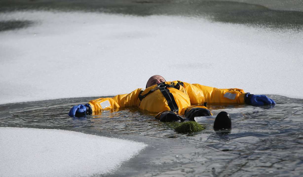 Battalion Chief Ben Bailey waits to be "rescued" as Lone Peak firefighters become certified in ice rescue at the Alpine Country Club in Highland on Friday, Jan. 26, 2018. (Photo: Jeffrey D. Allred, KSL)