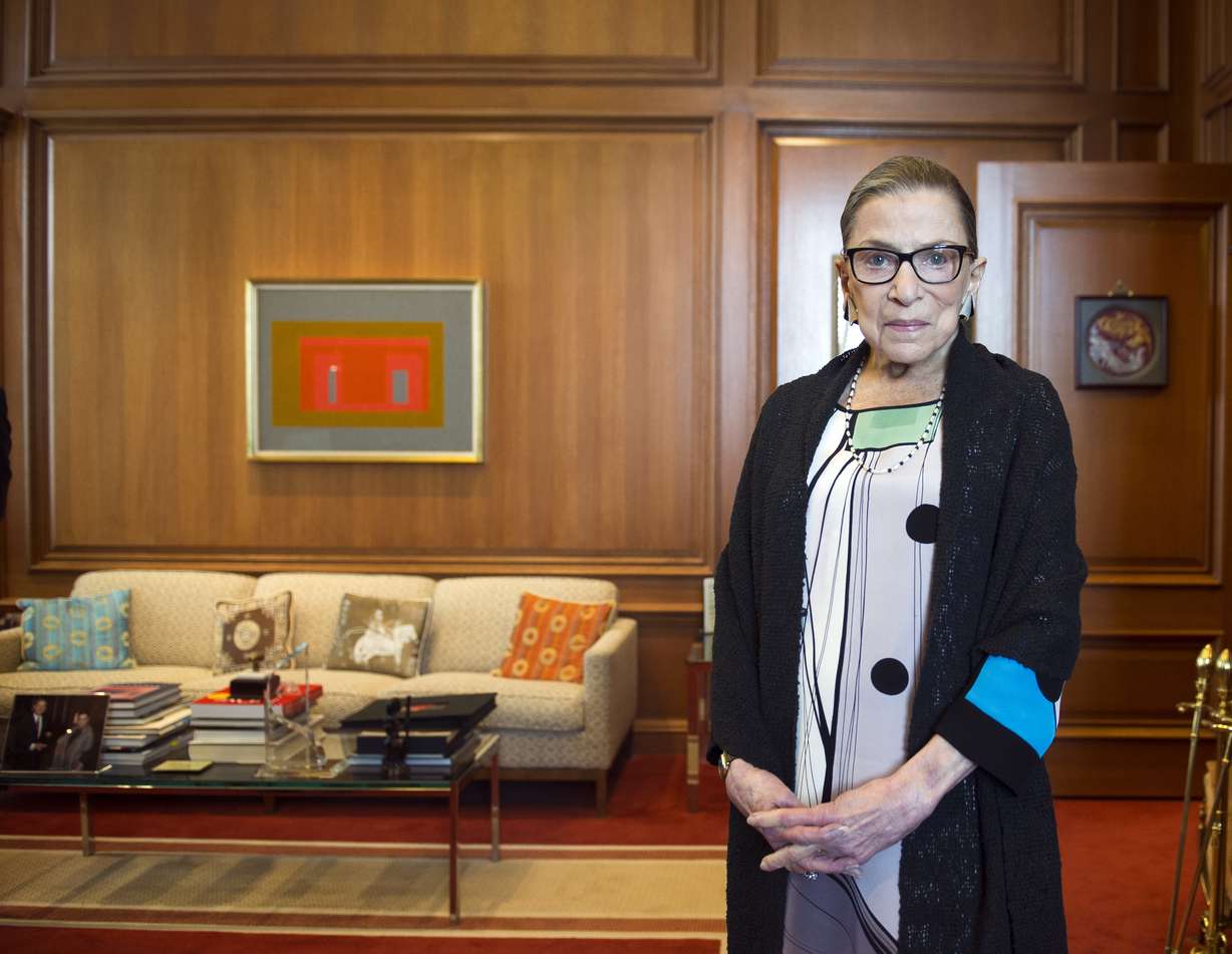 FILE - In this July 31, 2014, file photo, Associate Justice Ruth Bader Ginsburg in her Supreme Court chambers in Washington. In different circumstances, Ginsburg might be on a valedictory tour in her final months on the Supreme Court. But in the era of Donald Trump, the 84-year-old Ginsburg is packing her schedule and sending signals she intends to keep her seat on the bench for years.