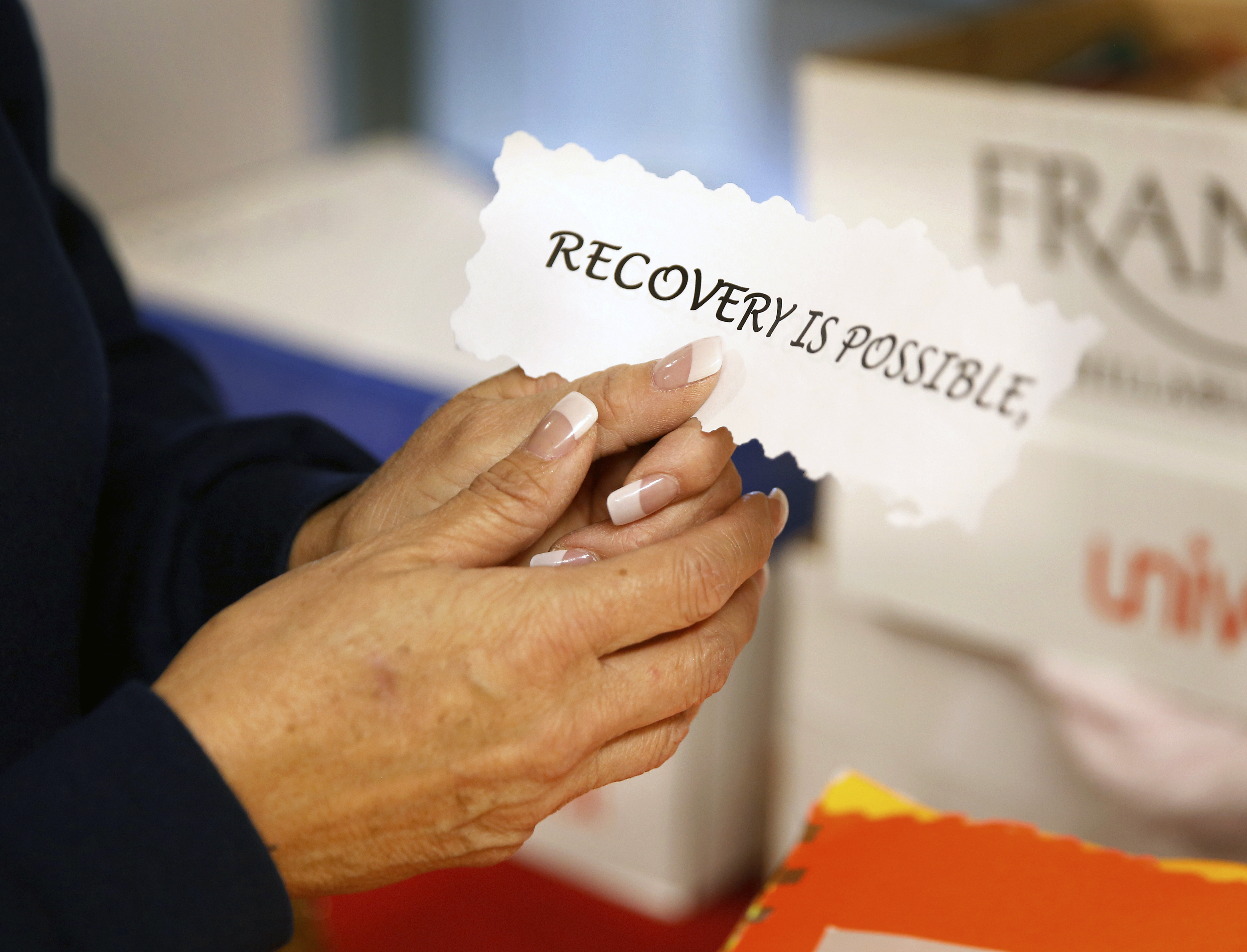 Joleen Valencia, who was held past her scheduled parole date while serving a drug-trafficking sentence, looks through her personal scrapbook at The Pavilions, a residential re-entry program in Los Lunas, N.M., where she received treatment after her release from prison. New Mexico prison records show the state has held hundreds of inmates, like Valencia, past their projected parole dates under a practice widely known as “in-house parole.” (Photo: Eric Draper, AP)