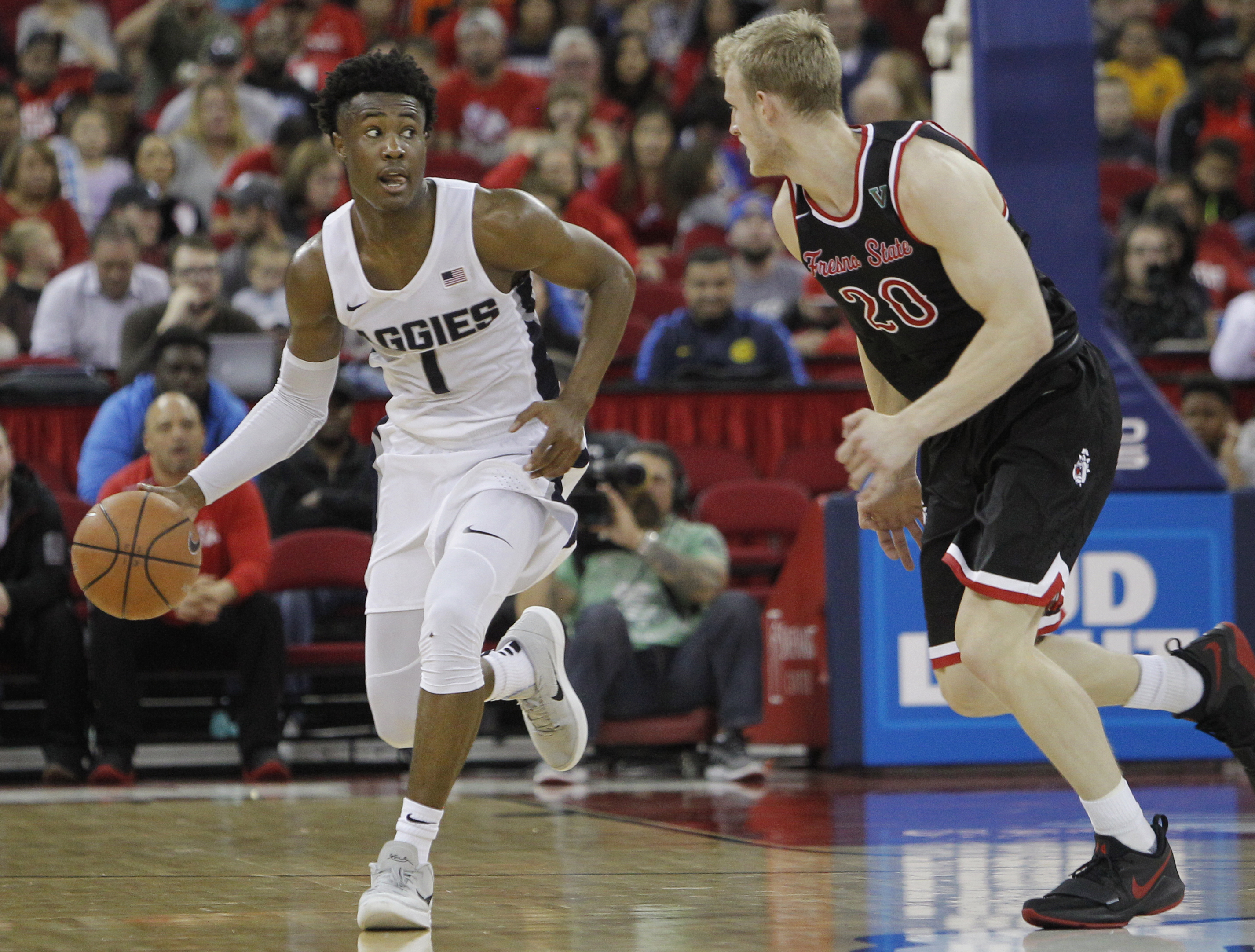 Utah State's Koby McEwen tries to drive around Fresno State's Sam Bittner during the second half of an NCAA college basketball game in Fresno, Calif., Saturday, Jan. 27, 2018.