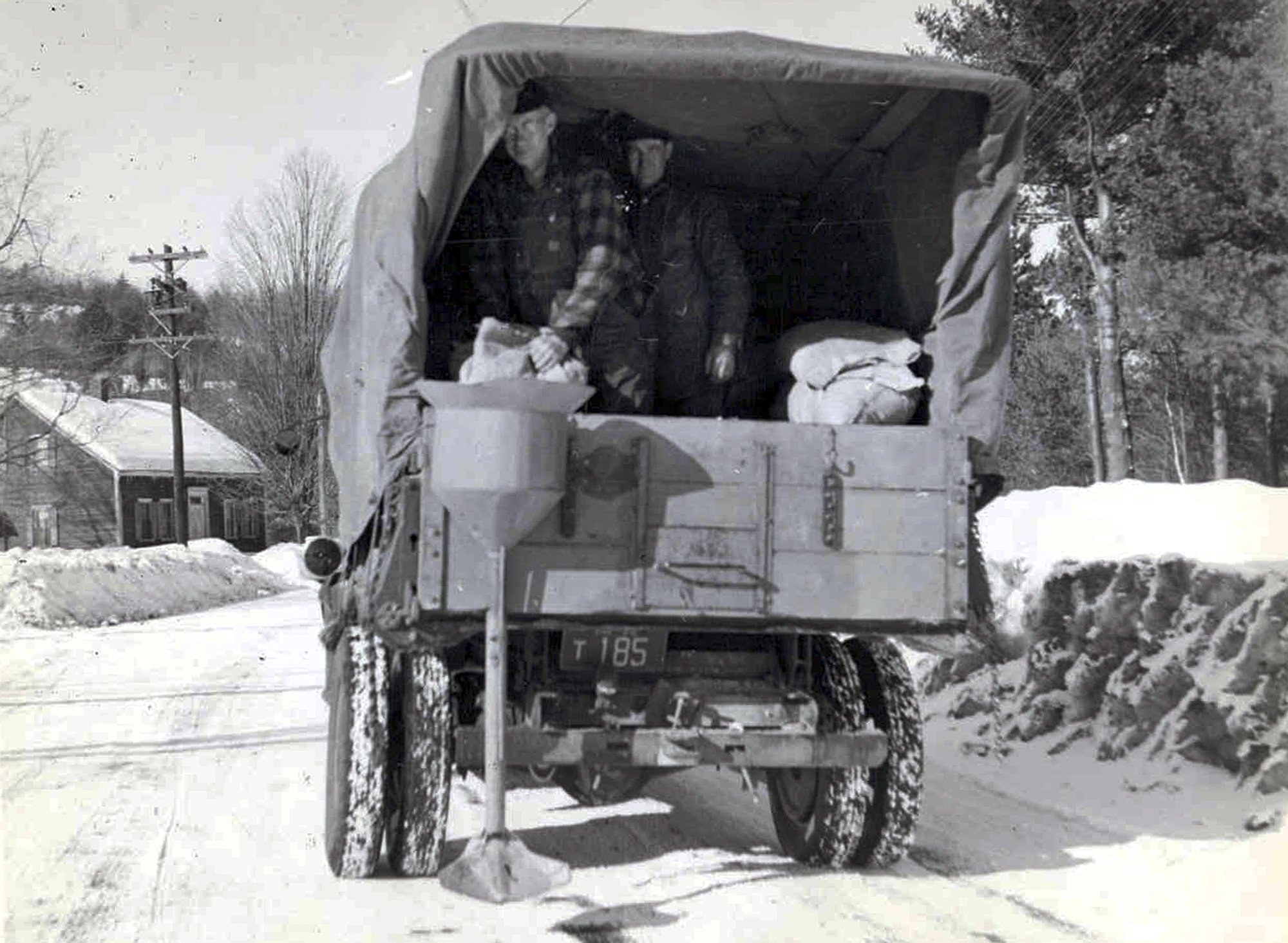 This circa 1940s photo released by the New Hampshire Department of Transportation archives shows salt being applied for anti-icing on a New Hampshire roadway. Some 20 million tons of salt is dispersed every year on American roads. Scientists in 2018 are starting to raise concerns about road salt's impact on the environment, especially drinking water, because lakes and streams near roads are showing elevated levels of sodium and chloride. (New Hampshire Department of Transportation via AP)