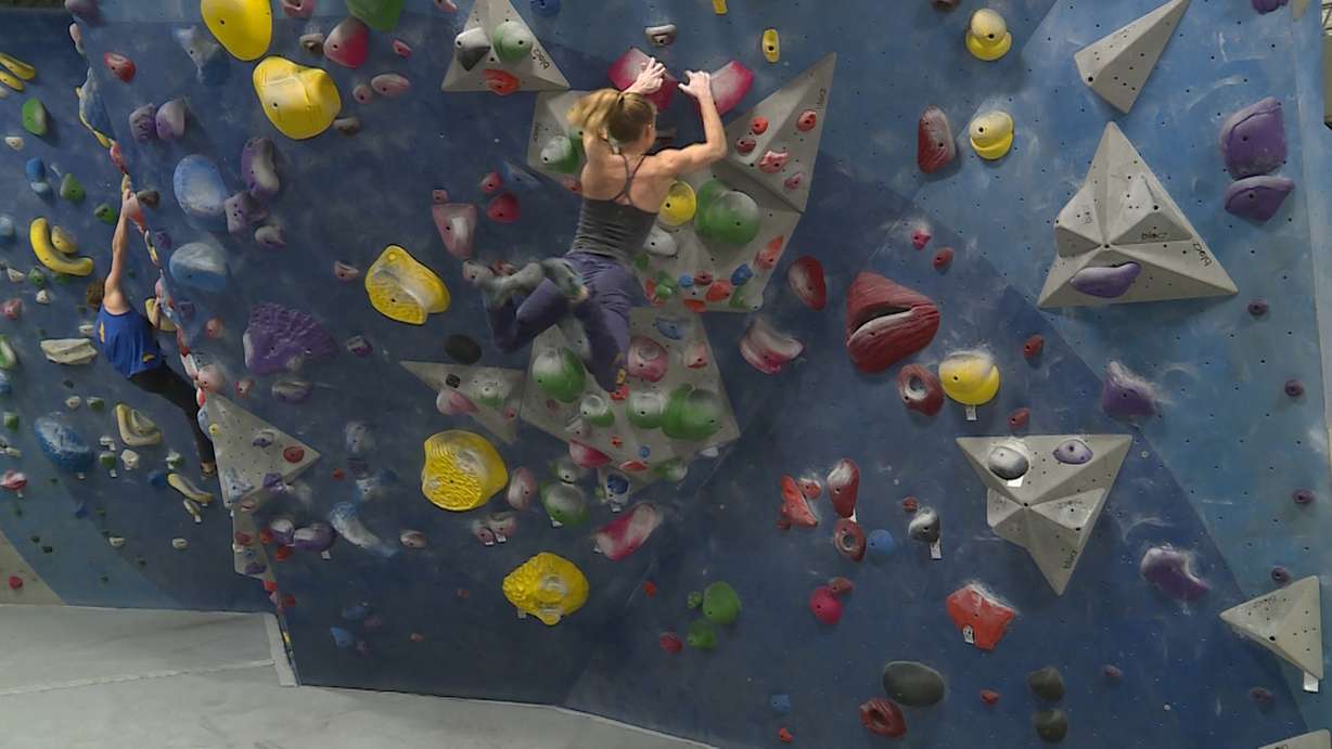 Sami Singleton swings from a wall after completing a jump at Momentum Indoor Climbing in Millcreek on January 23rd, 2018. (Photo: Ray Boone, KSL TV)