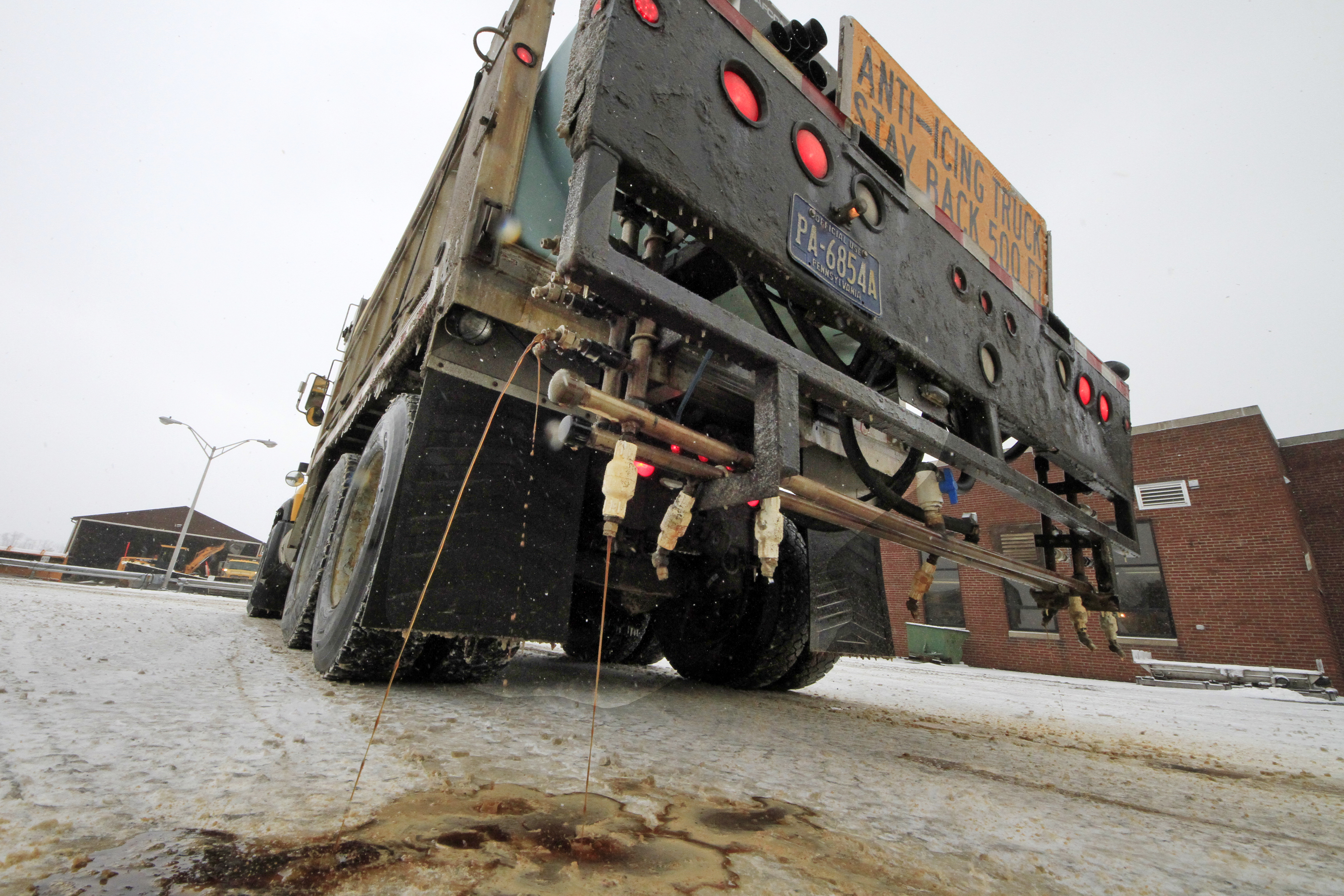 In a demonstration, a Pennsylvania Department of Transportation anti-icing truck sprays a de-icing cocktail of brine and beet juice on the driveway of PennDot's Butler, Pa., maintenance facility, Monday, Jan. 6, 2014. Because rock salt is largely ineffective below 16 degrees, additives, such as beet juice and cheese brine, can keep it working in temperatures as low as minus 25. (Gene J. Puskar, AP Photo, File)