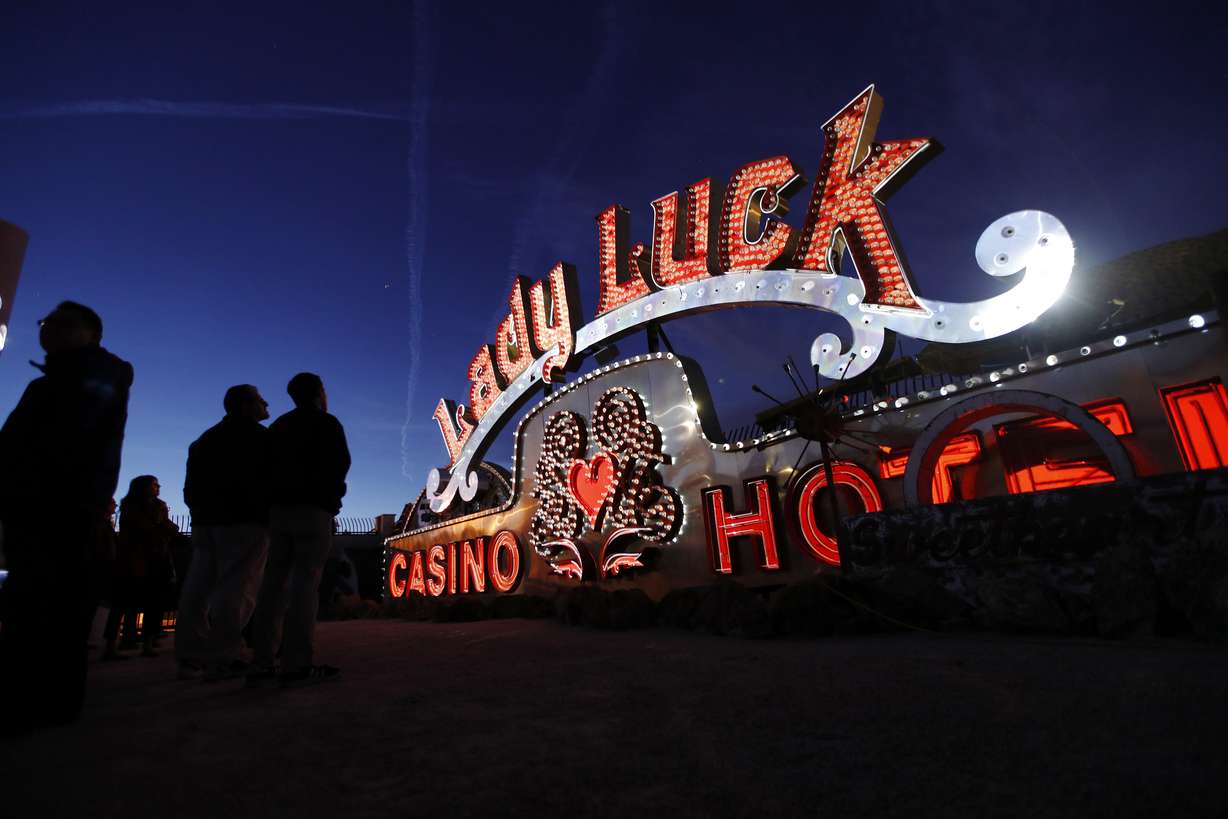 In this Jan. 24, 2018, photo, projectors light up non-working neon signs at an exhibit at the Neon Museum in Las Vegas. Starting this week, visitors will be able to see many of the city's classic neon signs just like they were decades ago through a type of augmented reality that projects realistic animations onto the non-working signs. (AP Photo/John Locher)