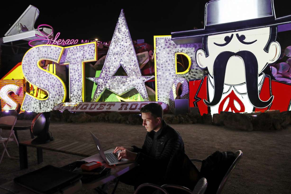 In this Jan. 24, 2018, photo, digital artist and designer Craig Winslow works on an exhibit at the Neon Museum in Las Vegas. Starting this week, visitors will be able to see many of the city's classic neon signs just like they were decades ago through a type of augmented reality that projects realistic animations onto the non-working signs. (AP Photo/John Locher)