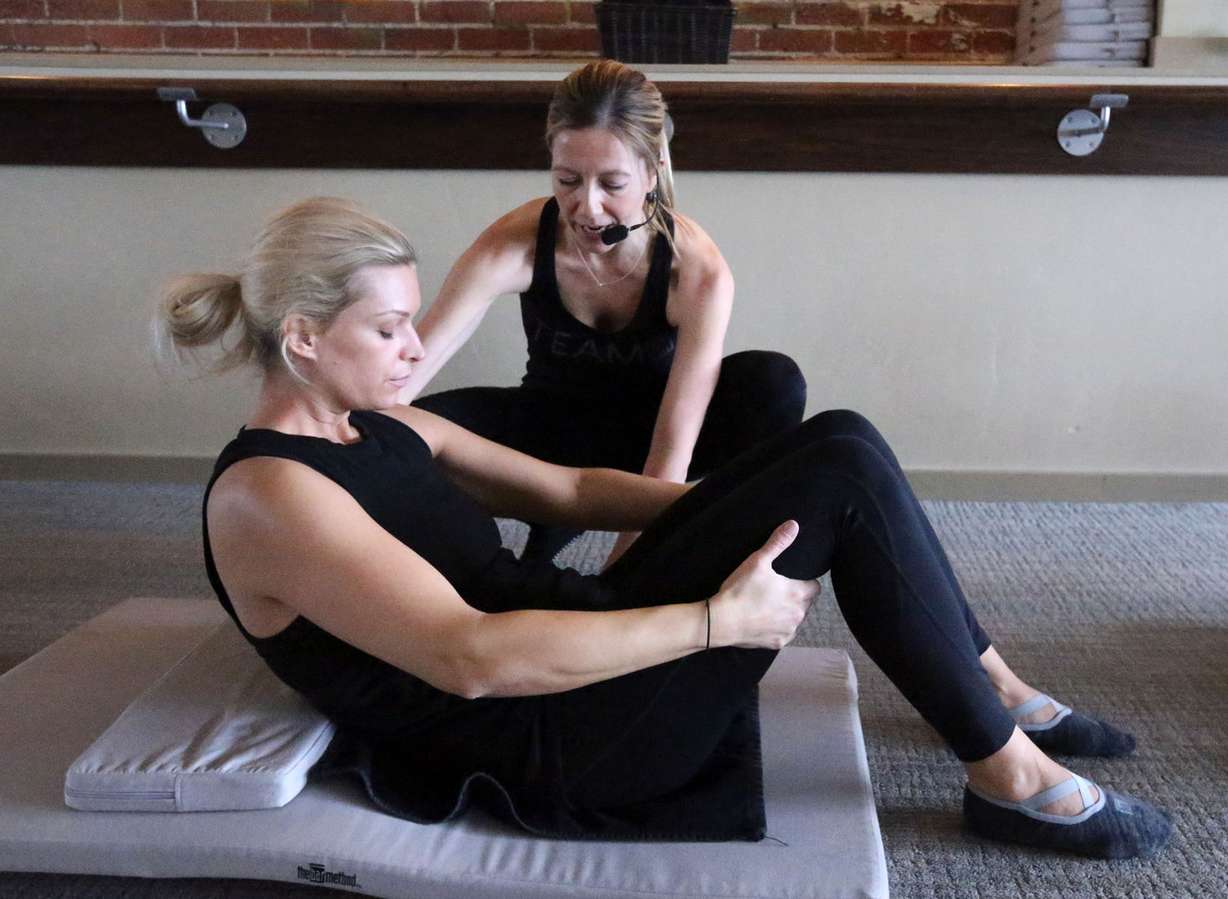Alison Richman helps Lauren Kennedy during a class at The Bar Method in Salt Lake City on Tuesday, Jan. 30, 2018. (Photo: Kristin Murphy, KSL)