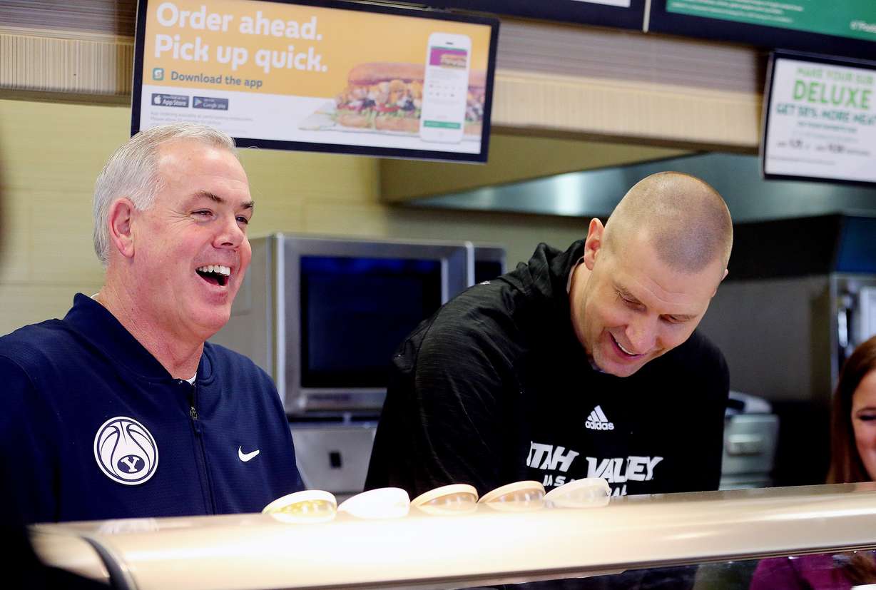 BYU's and UVU's head basketball coaches Dave Rose and Mark Pope team up to make sandwiches for customers at a Subway in Orem to show support for Coaches vs. Cancer on Tuesday, Jan. 30, 2018. Pope was named the next coach at BYU, replacing Rose, the university has announced. (Photo: Scott G Winterton, Deseret News)