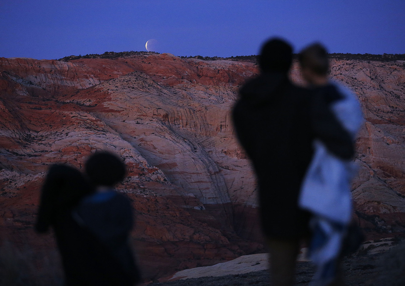 Anthony Christensen views the eclipse of a super blue blood moon with his sons, Logan and Alton, from above Snow Canyon State Park in Washington County on Wednesday, Jan. 31, 2018. (Photo: Ravell Call, KSL)