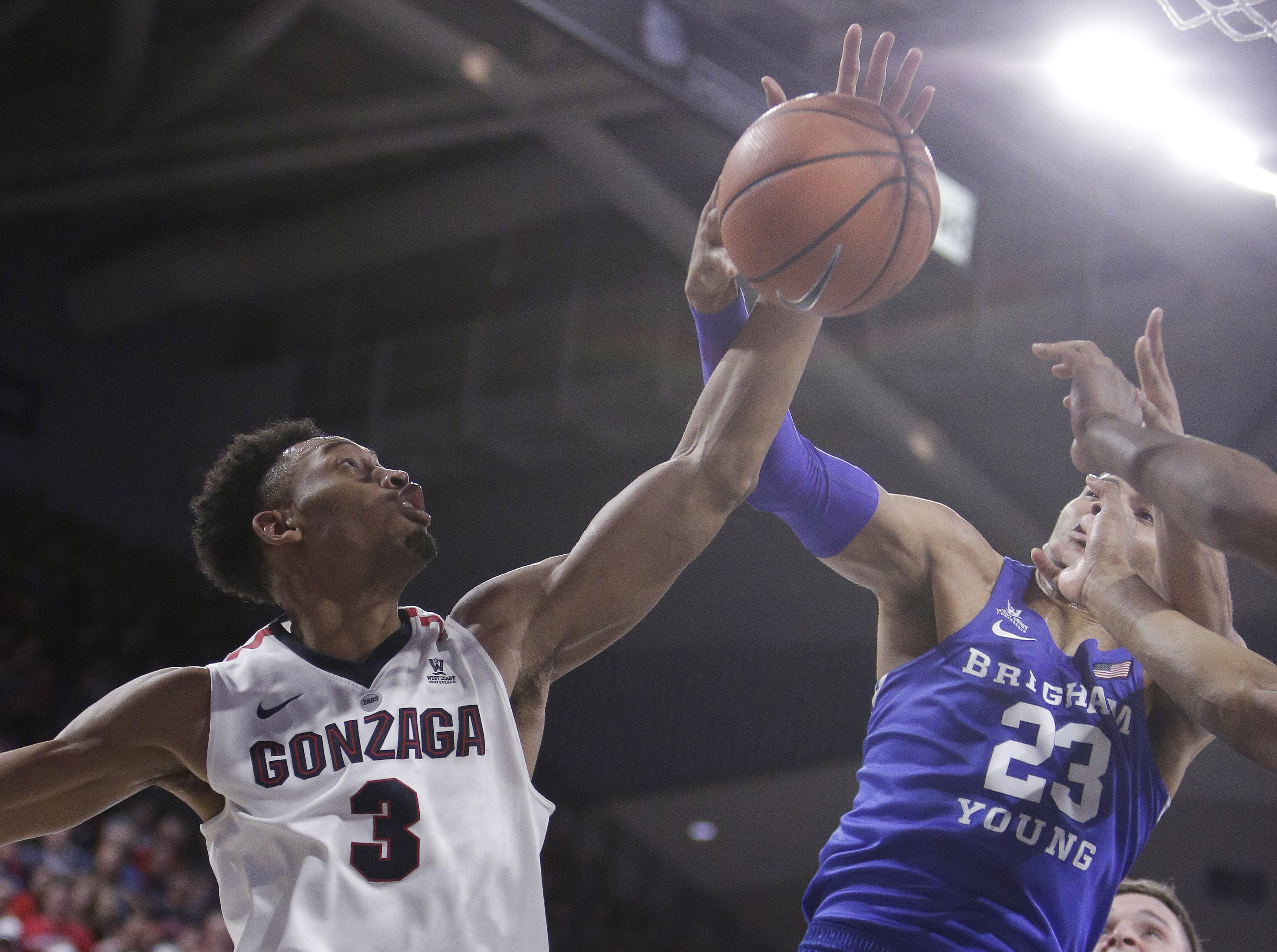 Gonzaga forward Johnathan Williams (3) and BYU forward Yoeli Childs (23) go after a rebound during the second half of an NCAA college basketball game in Spokane, Wash., Saturday, Feb. 3, 2018. Gonzaga won 68-60. (AP Photo, Young Kwak)