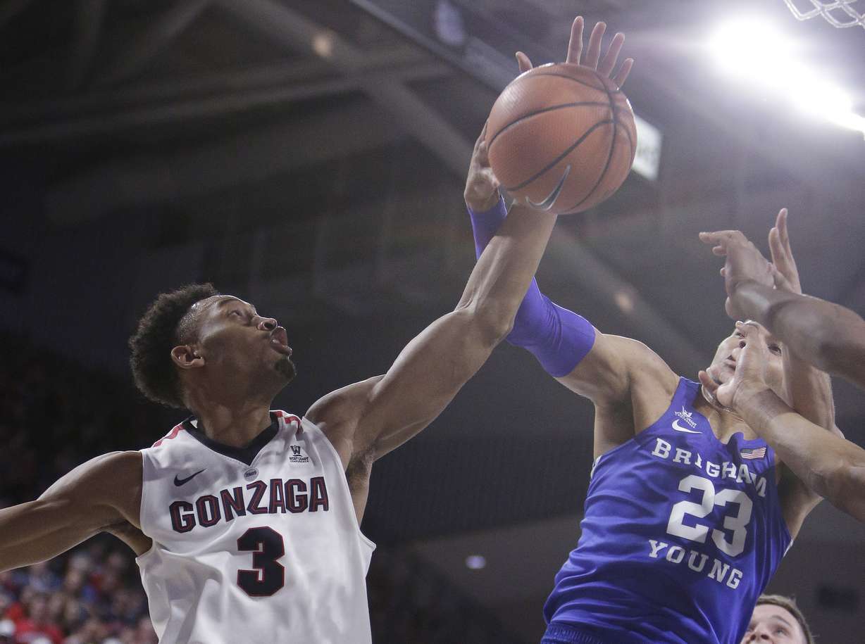 Gonzaga forward Johnathan Williams (3) and BYU forward Yoeli Childs (23) go after a rebound during the second half of an NCAA college basketball game in Spokane, Wash., Saturday, Feb. 3, 2018. Gonzaga won 68-60. (AP Photo, Young Kwak)