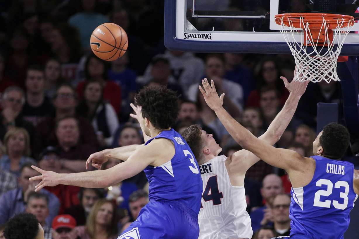BYU guard Elijah Bryant (3) blocks a shot by Gonzaga forward Corey Kispert, middle, during the second half of an NCAA college basketball game in Spokane, Wash., Feb. 3, 2018. BYU's Yoeli Childs is at right. Gonzaga won 68-60. (AP Photo, Young Kwak)