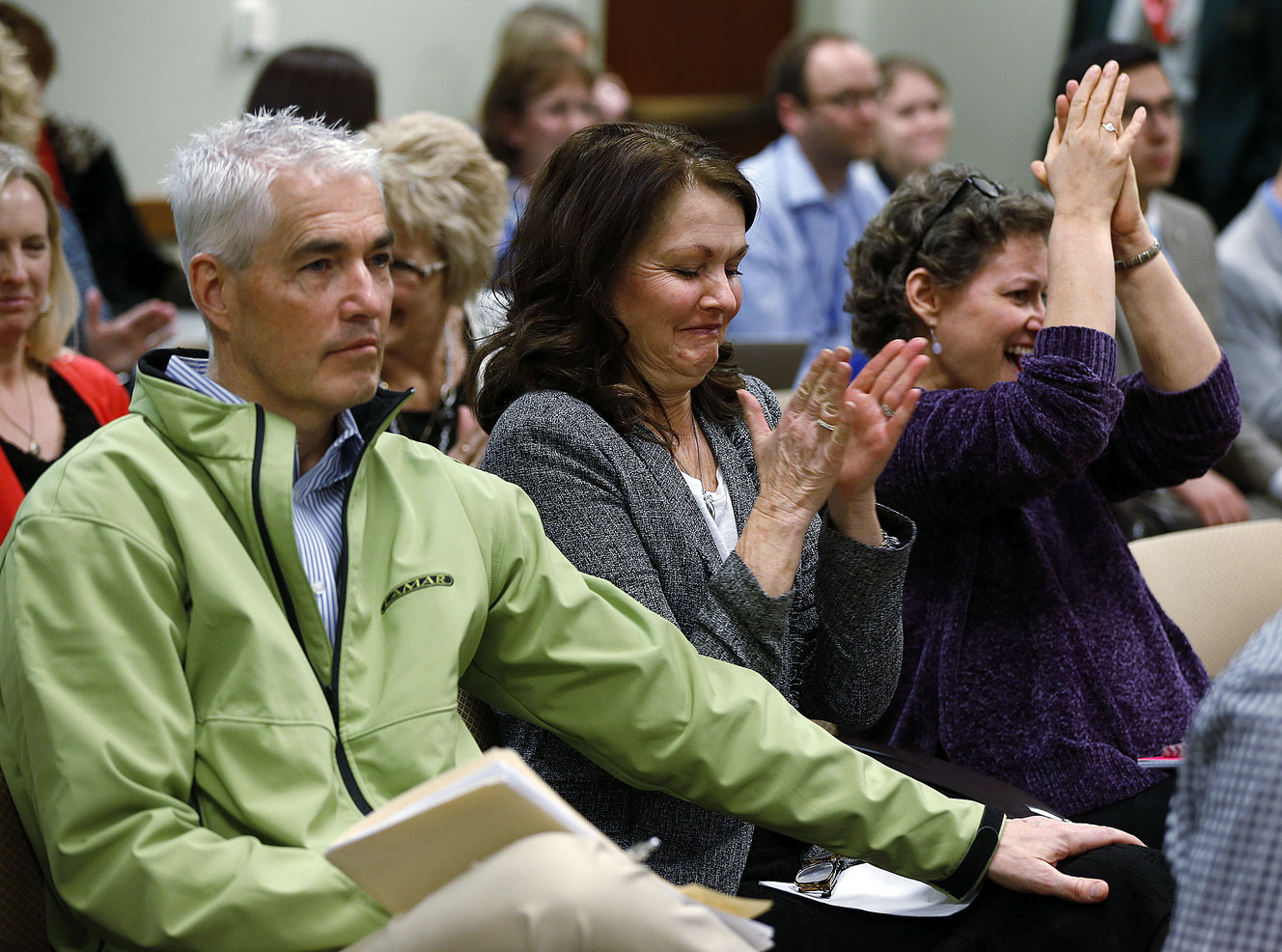 Darla Stevenson, right, and Colette Moser applaud after HB258 passes out of committee with a favorable recommendation at the Capitol in Salt Lake City on Monday, Feb. 5, 2018. Both have had breast cancer. Colette's brother, Corey Headman, joins at left in support. (Photo: Ravell Call, KSL)