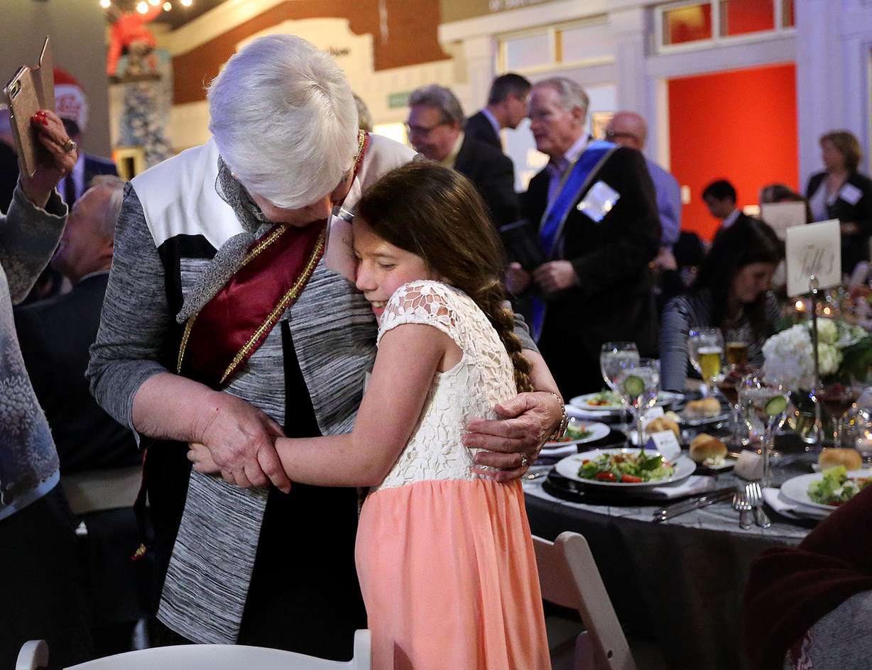 Gail Miller hugs her granddaughter Elizabeth Miller before getting inducted into the Junior Achievement Utah Business Hall of Fame. Photo: Kristin Murphy, KSL