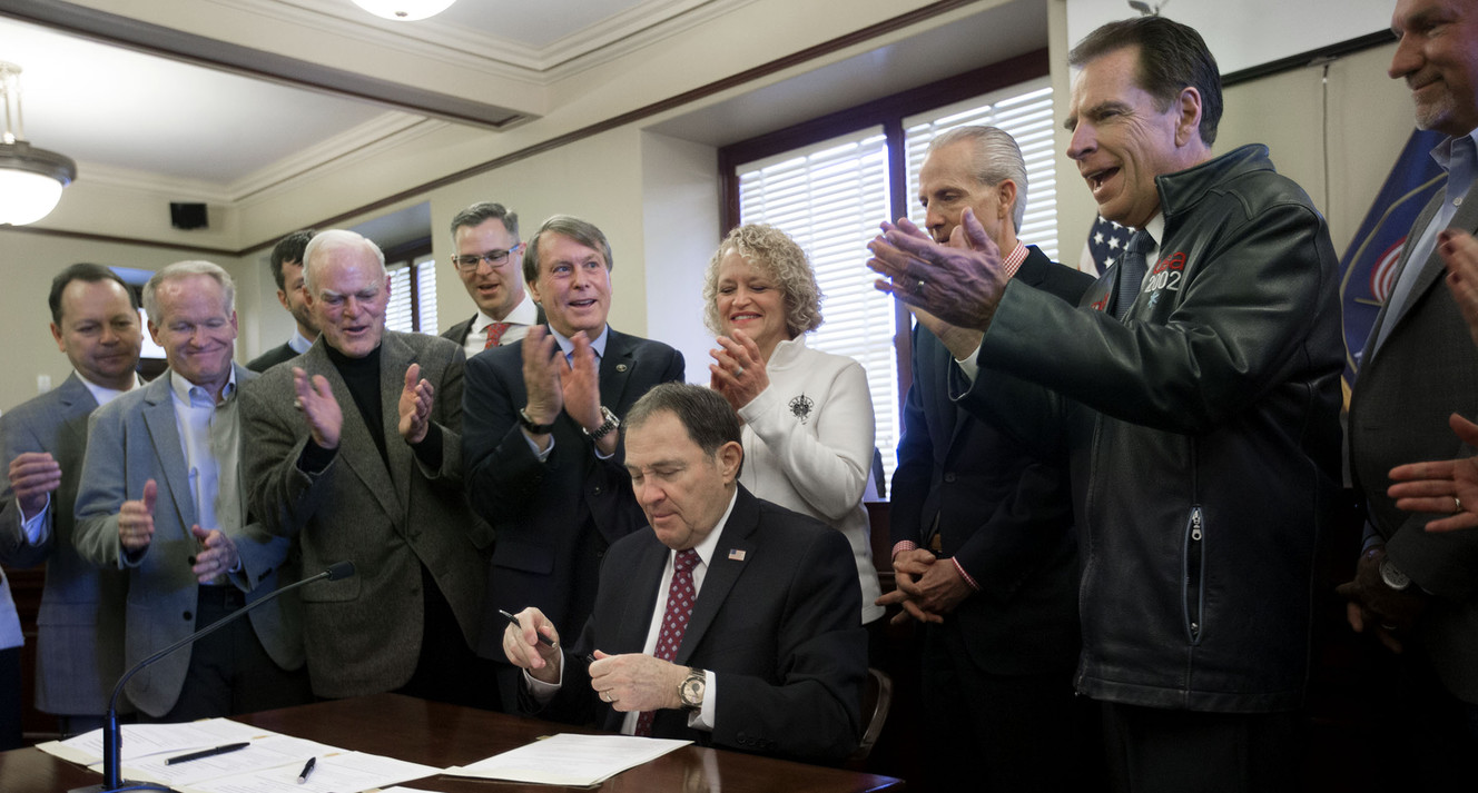 Members of the Olympic Exploratory Committee applaud after Gov. Gary Herbert signed SCR009 — a resolution passed by the Legislature declaring the state “ready, willing and able” to host another Olympics — during a meeting at the Capitol in Salt Lake City on Wednesday, Feb. 7, 2018. The committee voted unanimously in favor of recommending that Salt Lake City submit a bid for the 2026 and 2030 Winter Olympics. (Photo: Laura Seitz, KSL)