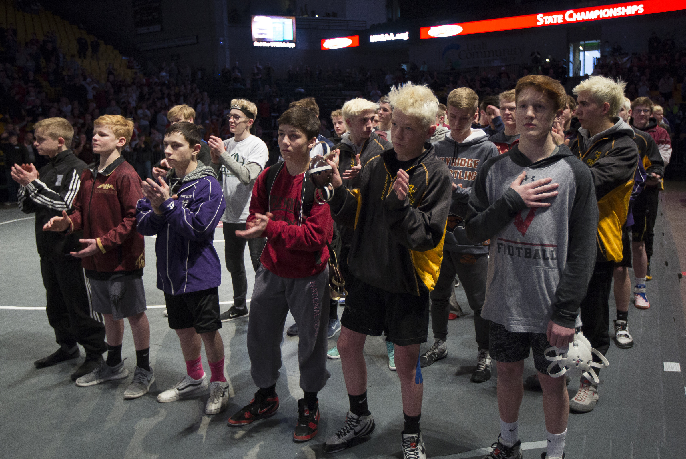Wrestlers clap following the national anthem during the UHSAA 5A/6A State Wrestling Championships at the Utah Valley University in Orem on Thursday, Feb. 8, 2018. (Photo: Jacob Wiegand, Deseret News)
