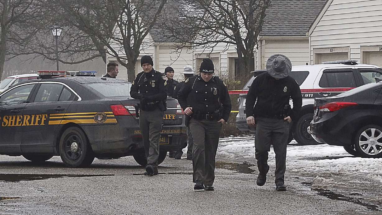 The Latest: Police identify suspect in 2 officers' shootings