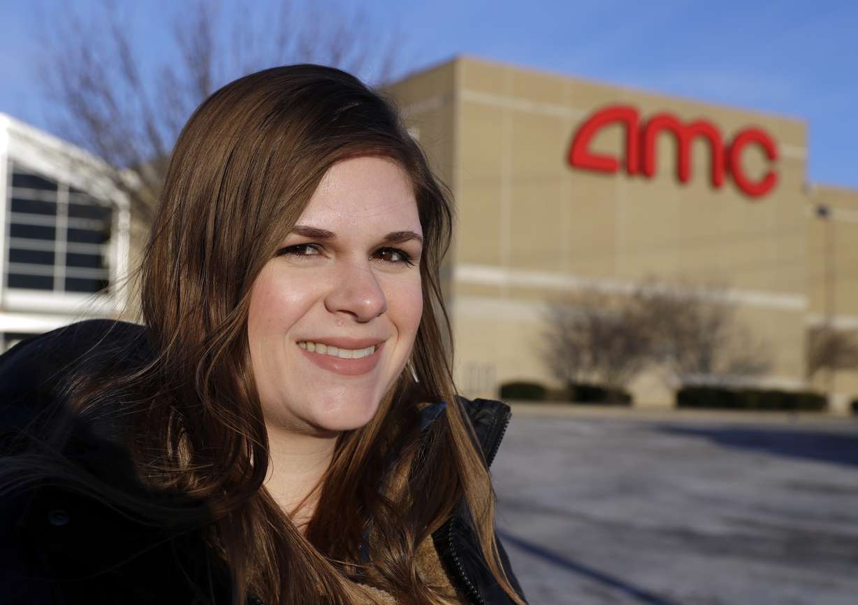 In this Tuesday, Jan. 30, 2018, photo, Cassie Langdon stands outside of AMC Indianapolis 17 theatre in Indianapolis. With MoviePass, Langdon said she's taking more chances on smaller releases instead of sticking with blockbusters and their sequels. (AP Photo/Darron Cummings)