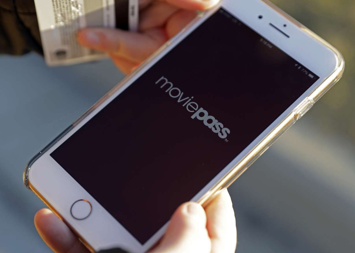 In this Tuesday, Jan. 30, 2018, photo, Cassie Langdon uses to her phone to launch the MoviePass app to see what movies are available at AMC Indianapolis 17 theatre in Indianapolis. With MoviePass, Langdon said she's taking more chances on smaller releases instead of sticking with blockbusters and their sequels. (AP Photo/Darron Cummings)