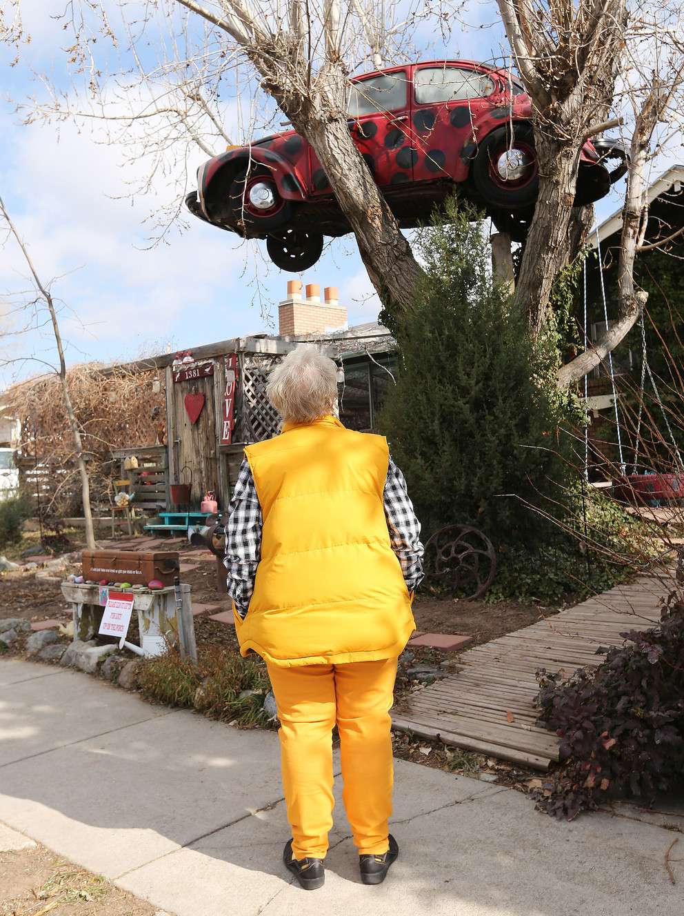 Janis Zettel looks at her car, “Lucy,” prior to crews removing it from a tree her front yard in Clearfield on Tuesday, Feb. 13, 2018. he City Council ruled the Volkswagen Beetle, which is painted to resemble a ladybug, a nuisance. (Photo: Jeffrey D. Allred, KSL)