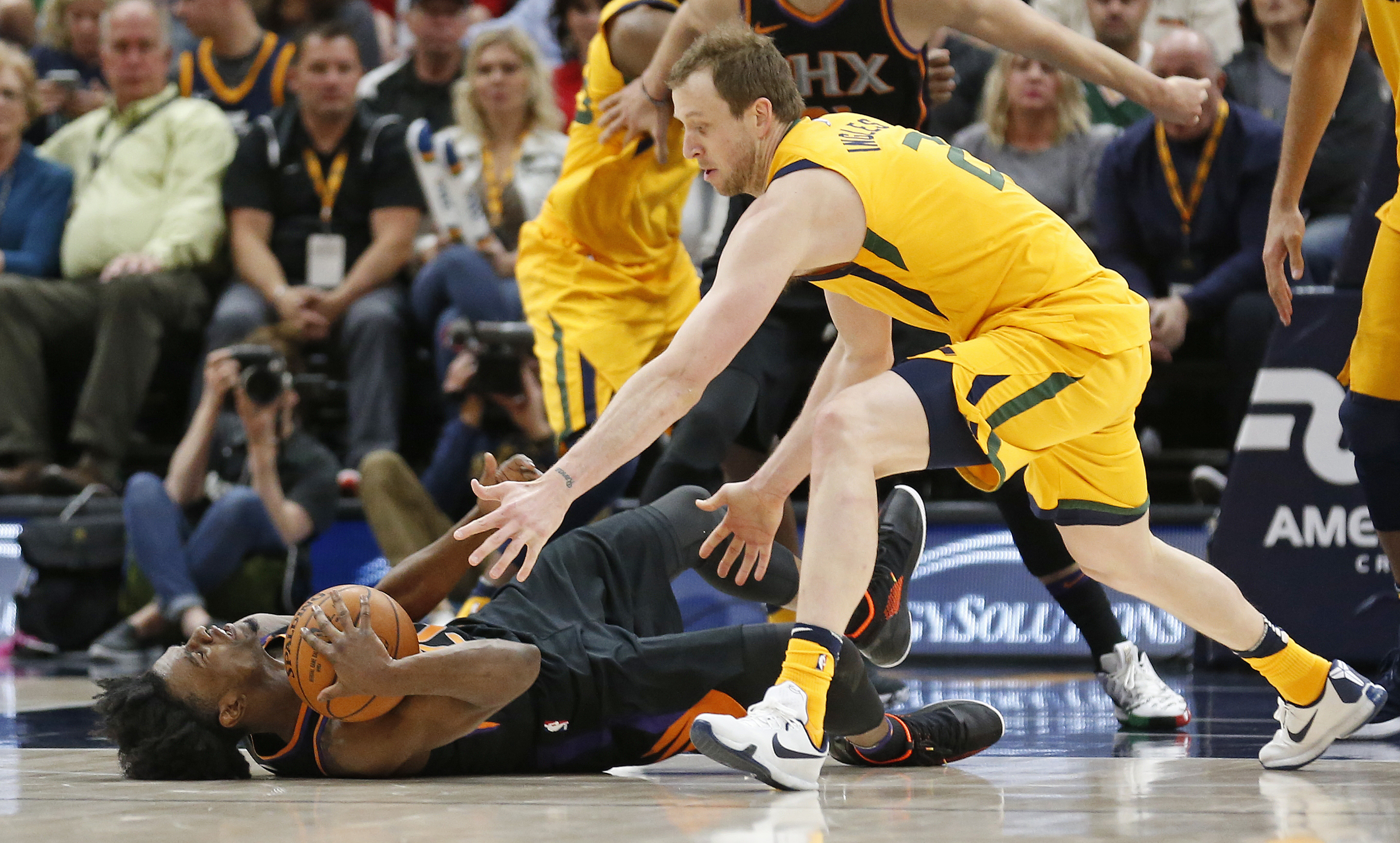 Phoenix Suns forward Josh Jackson, left, and Utah Jazz forward Joe Ingles, right, battle for a loose ball in the first half during an NBA basketball game Wednesday, Feb. 14, 2018, in Salt Lake City. (AP Photo, Rick Bowmer)