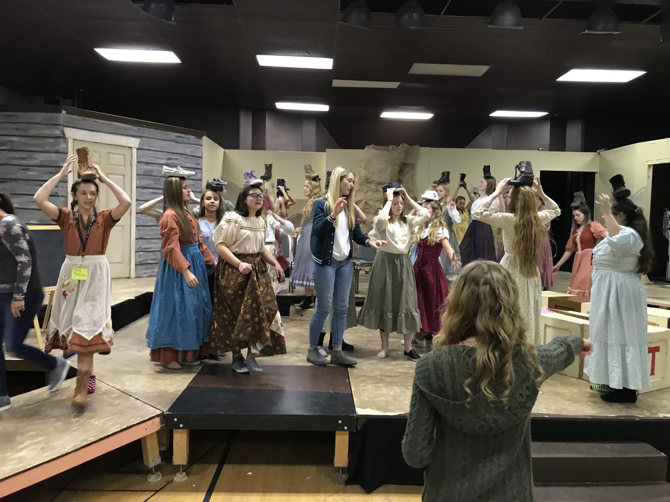 The cast of "Princess Academy" rehearses a scene at Timpanogos Valley Theater. Mia Walker, the blind lead actress in the show, uses sighted guides, a cane and set pieces to orient herself on stage. (Photo: Courtesy of Andrea Scott)