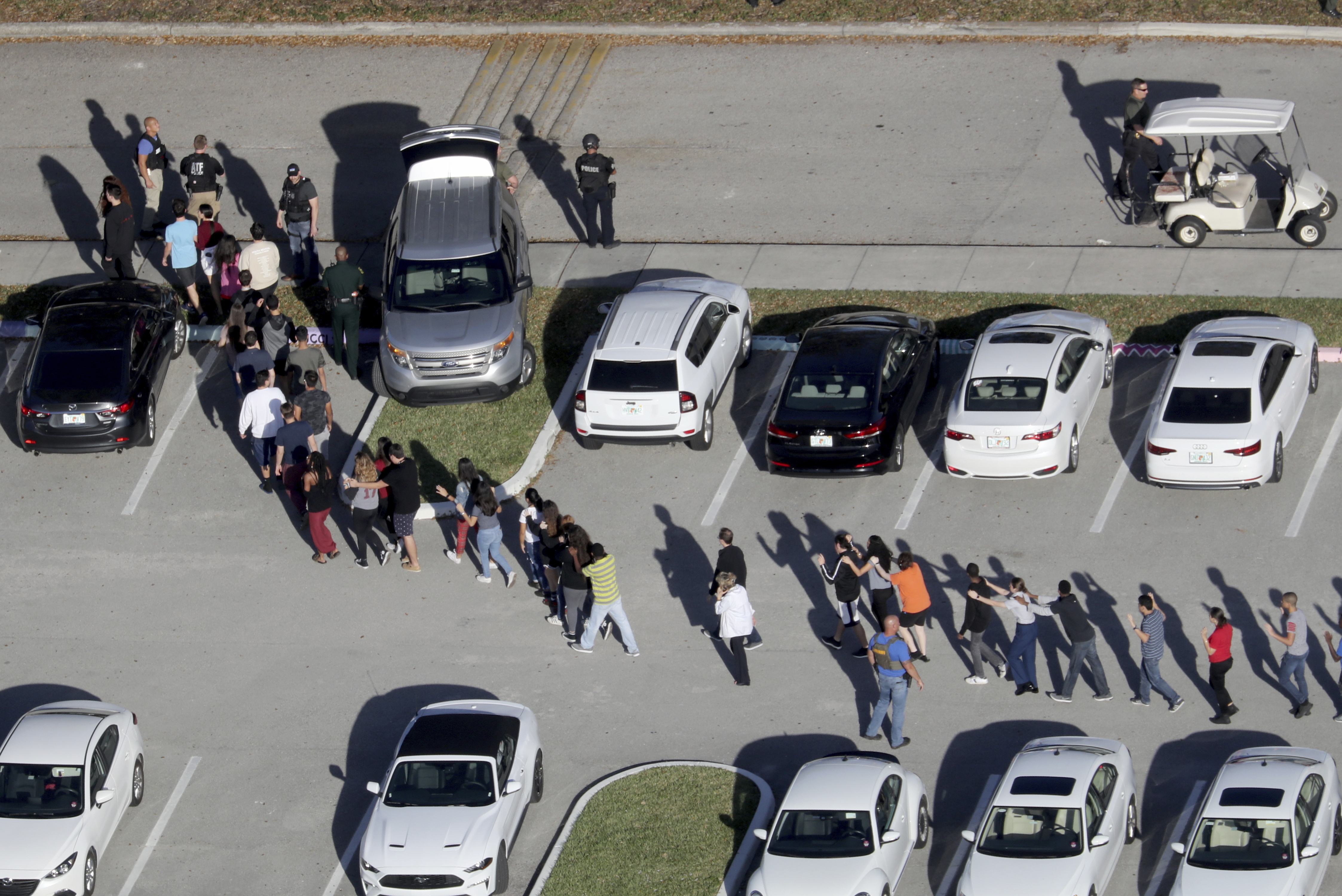 FILE - In this Feb. 14, 2018, file photo, students are evacuated by police from Marjory Stoneman Douglas High School in Parkland, Fla., after a shooter opened fire on the campus. Modern technology has enabled real-time reaction, support and calls for action during deadly mass shootings in the U.S. Live video of the Florida shooting showed survivors under desks while others live-tweeted messages to the survivors. (Mike Stocker/South Florida Sun-Sentinel via AP, File) (Photo: Mike Stocker, South Florida Sun-Sentinel)