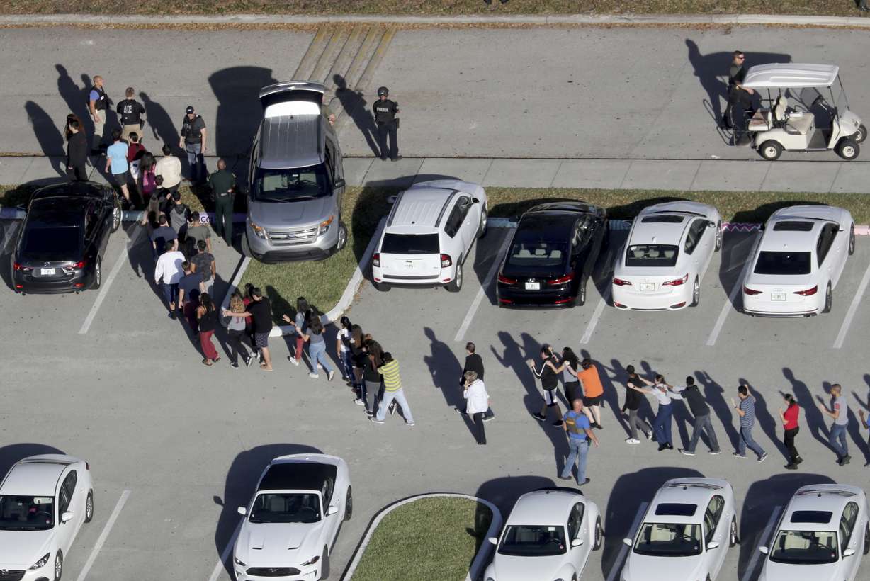 FILE - In this Feb. 14, 2018, file photo, students are evacuated by police from Marjory Stoneman Douglas High School in Parkland, Fla., after a shooter opened fire on the campus. Modern technology has enabled real-time reaction, support and calls for action during deadly mass shootings in the U.S. Live video of the Florida shooting showed survivors under desks while others live-tweeted messages to the survivors. (Mike Stocker/South Florida Sun-Sentinel via AP, File) (Photo: Mike Stocker, South Florida Sun-Sentinel)