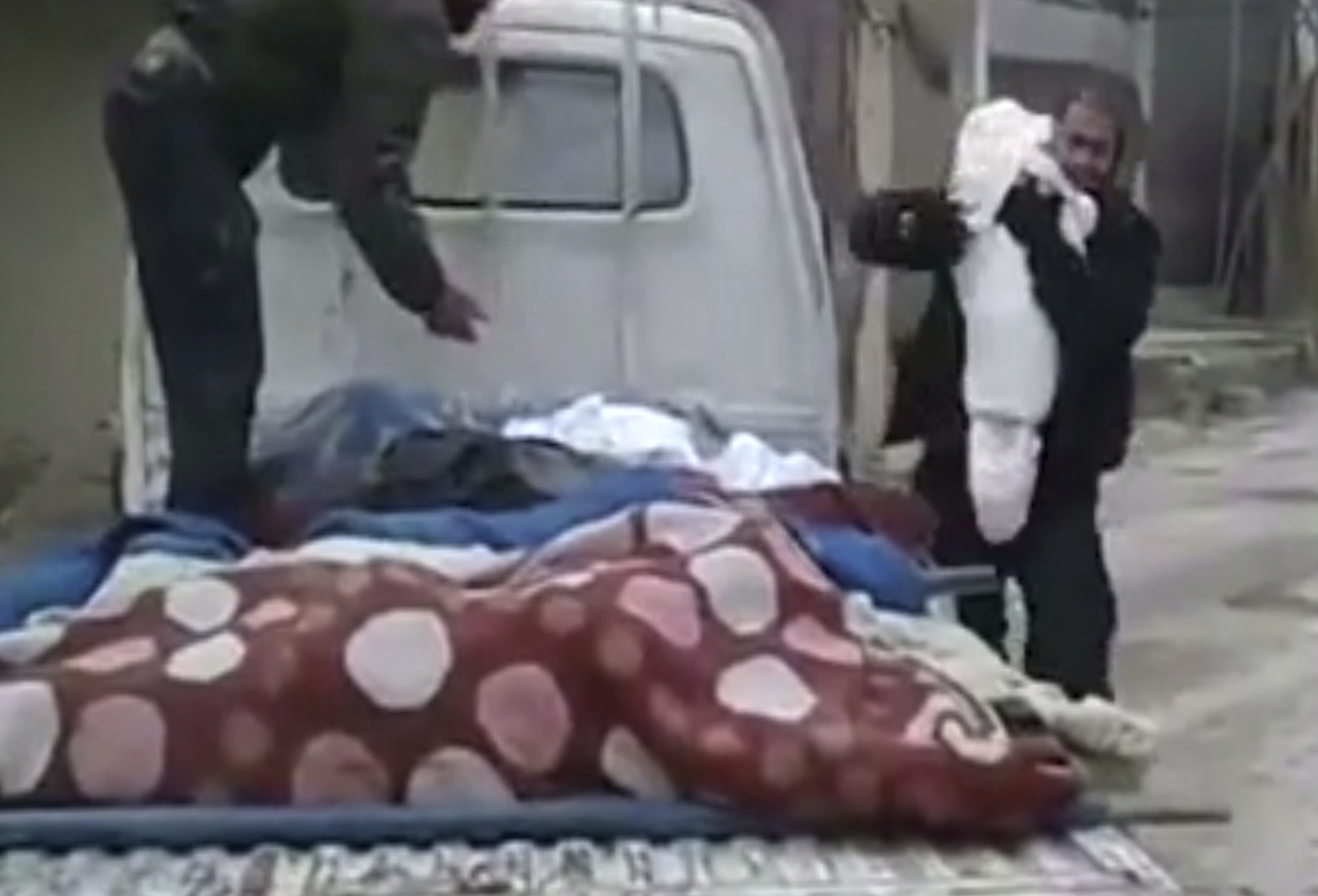 In Syria, a father says last goodbye to dead child