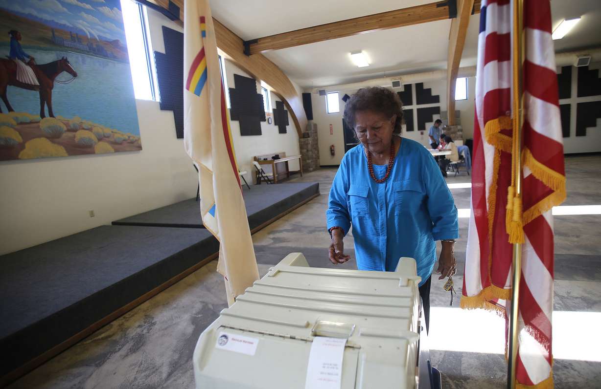 Martha Johnson turns in her ballot at the Nenahnezad Chapter House in Fruitland, N.M., during the Navajo Nation's referendum election to decide the language qualifications for future leaders in this July 21, 2015, file photo. Navajos who once worried they'd have to drive hours to cast their ballots in Utah say a new settlement is a step forward as tribes challenge what they call discriminatory voting practices around the United States. (Photo: Jon Austria, The Daily Times)